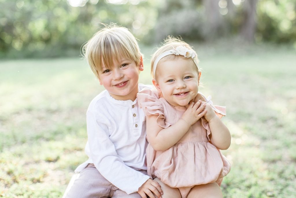 Tampa family photographer taking beautiful outdoor photos in open grassy area
