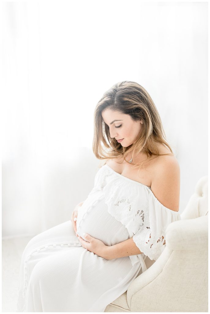 Newborn natural lighting photographer taking Tampa Florida smile-filled studio maternity photos