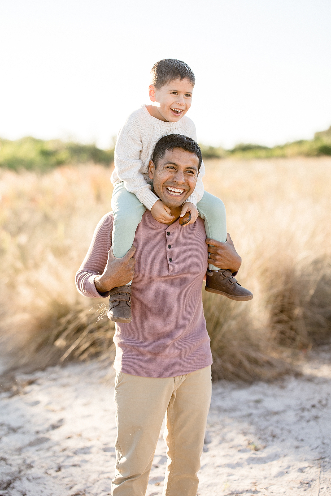 Son riding piggy back on Dad's shoulders. Photos by Brittany Elise Photography.
