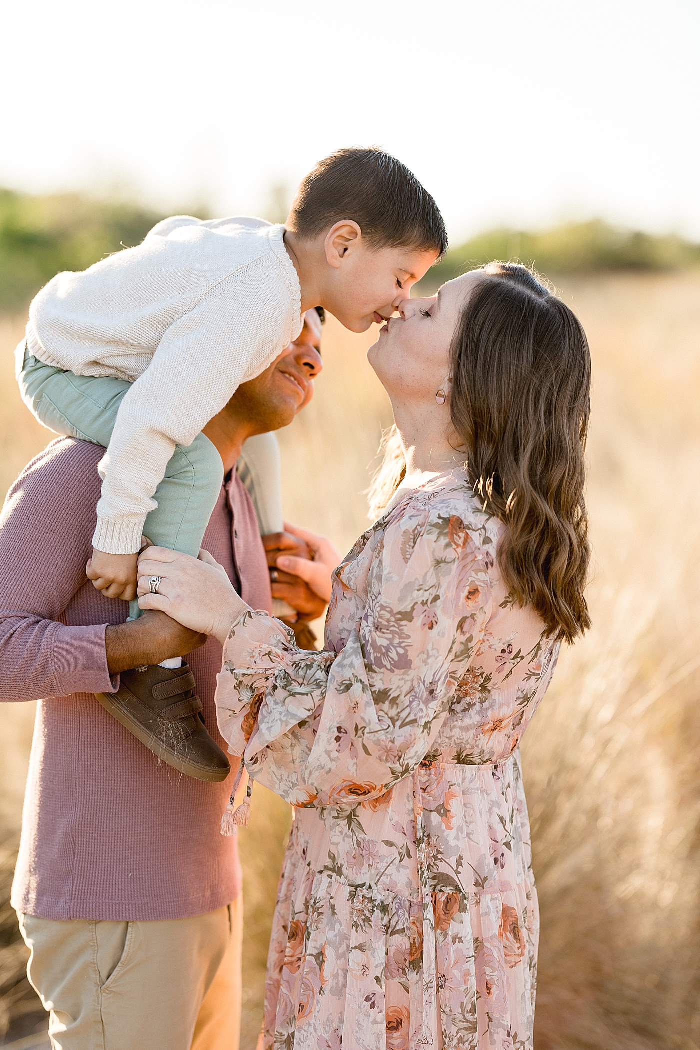 Toddler giving Mom a kiss during family photos with Brittany Elise Photography.