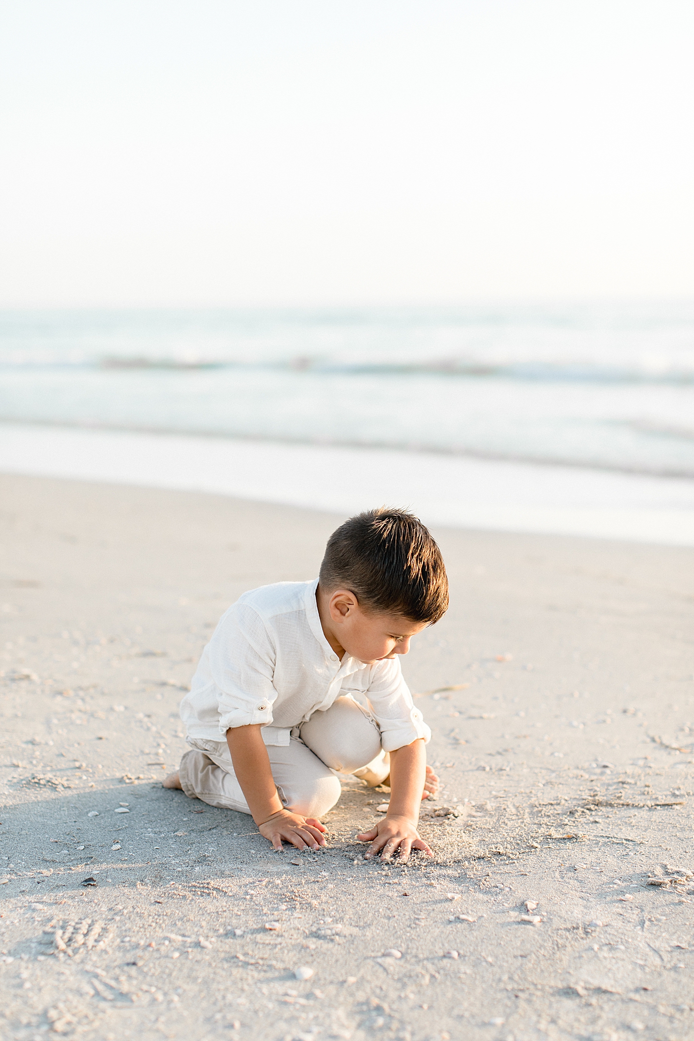 Young boy playing in the sand. Photos by Tampa Children's Photographer, Brittany Elise Photography.