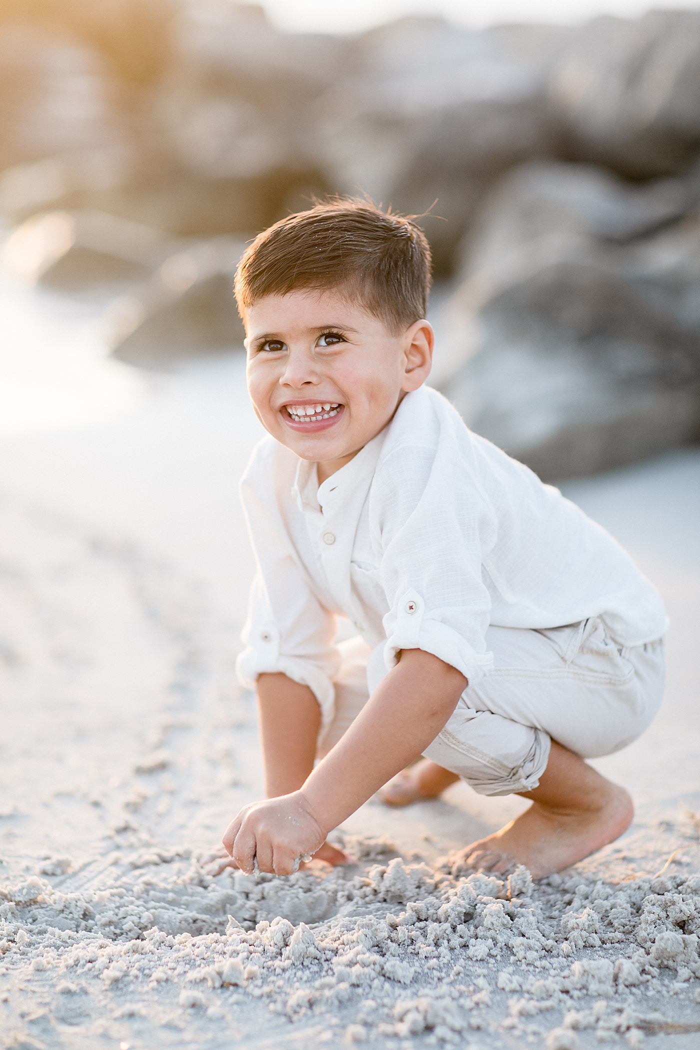 Young boy smiling so big during his family photoshoot with Brittany Elise Photography.