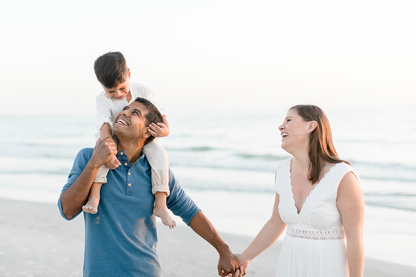 Fun moment between Mom, Dad and Son on the beach. Photos by Brittany Elise Photography.