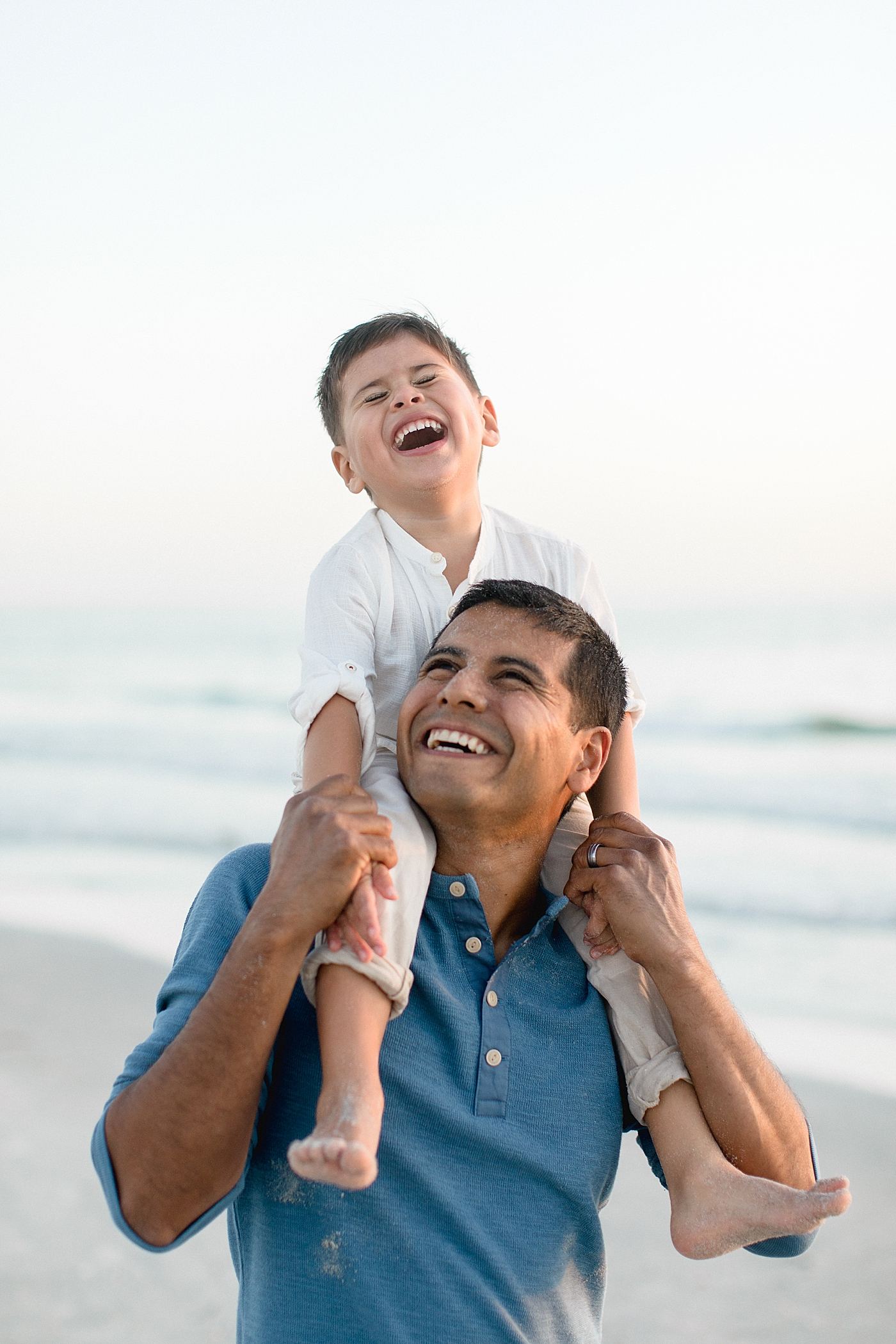 Father and son laughing together. Photos by Brittany Elise Photography.