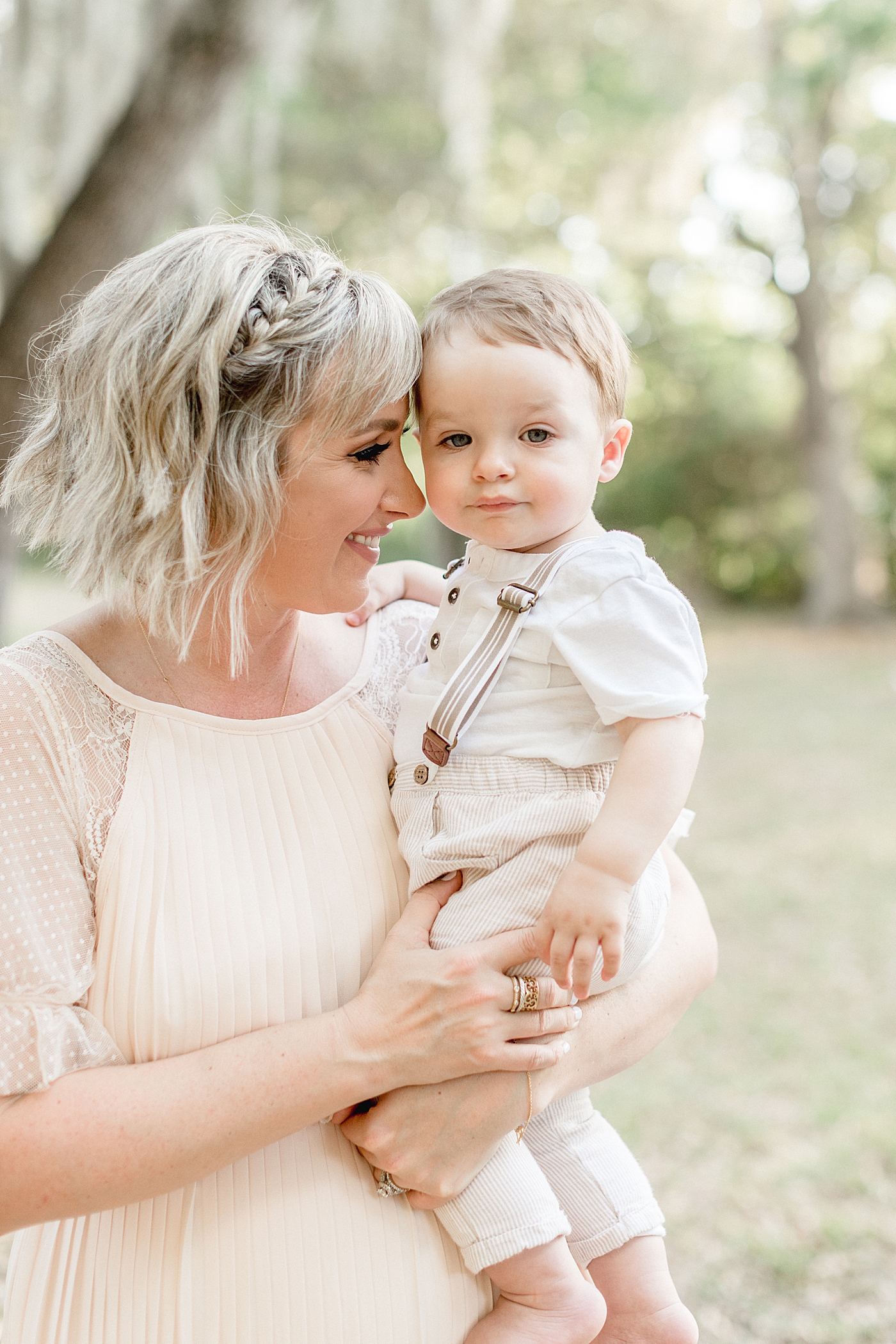 Mom holding her one year old son for his first birthday photoshoot. Photo by Brittany Elise Photography.