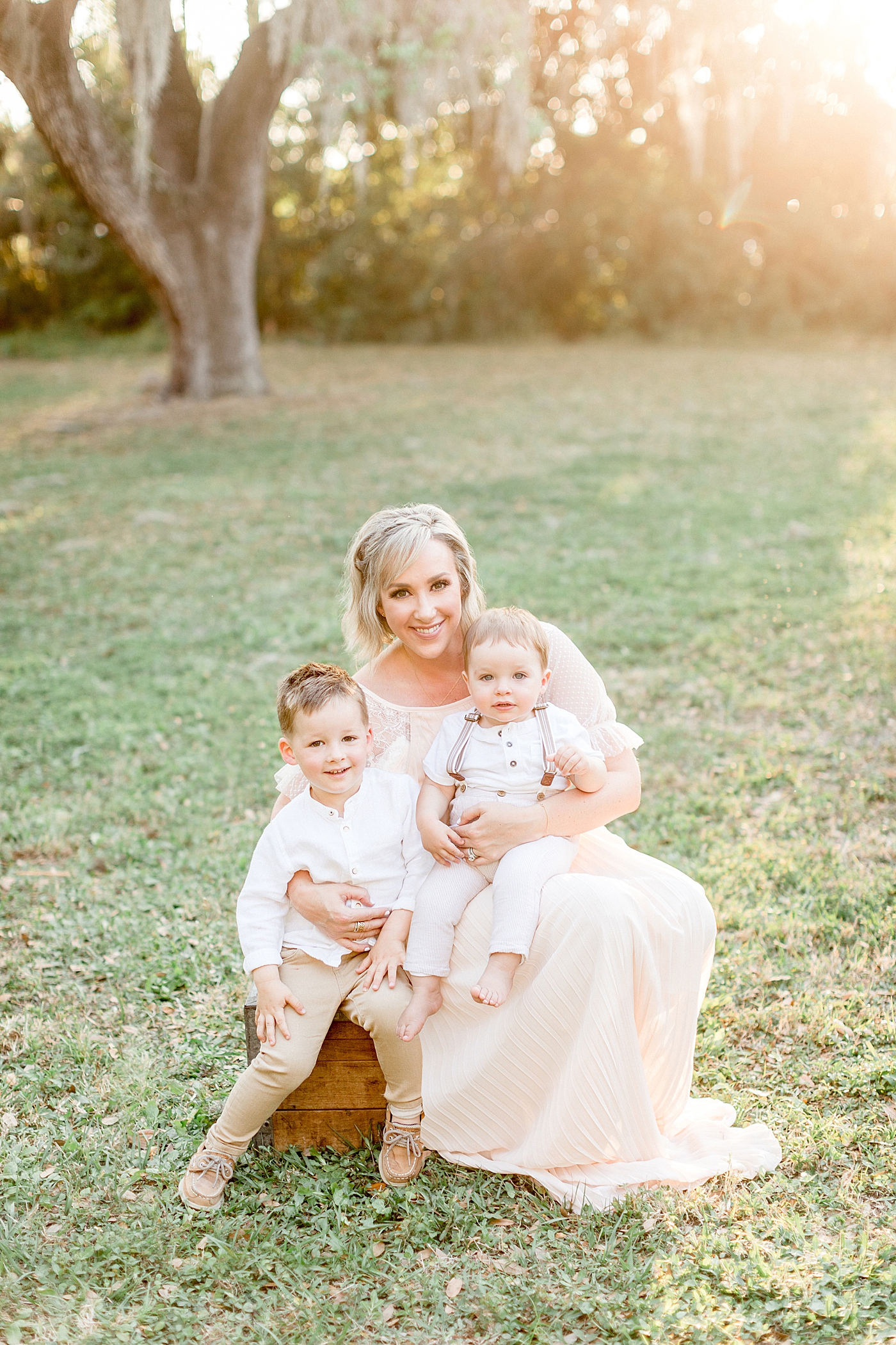 Sunset photo of Mom and two sons. Photo by Brittany Elise Photography.