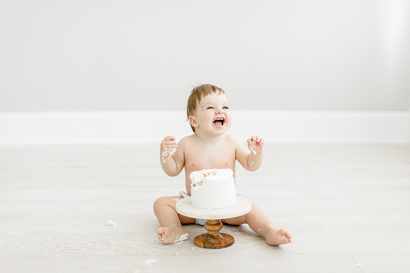 One year old cake smash in Tampa photography studio. Photo by Brittany Elise Photography.