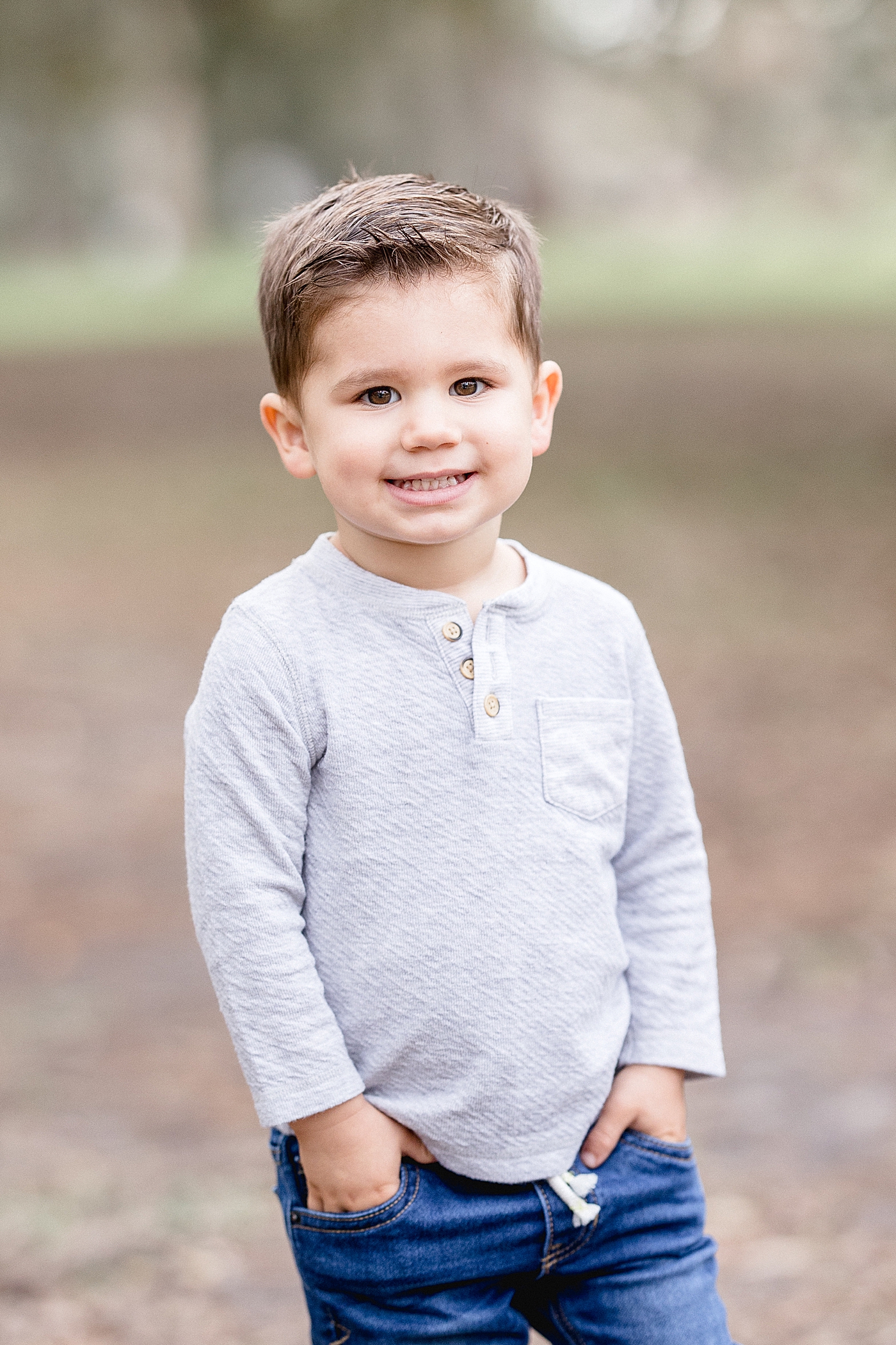 Toddler boy standing for portrait with Brittany Elise Photography.