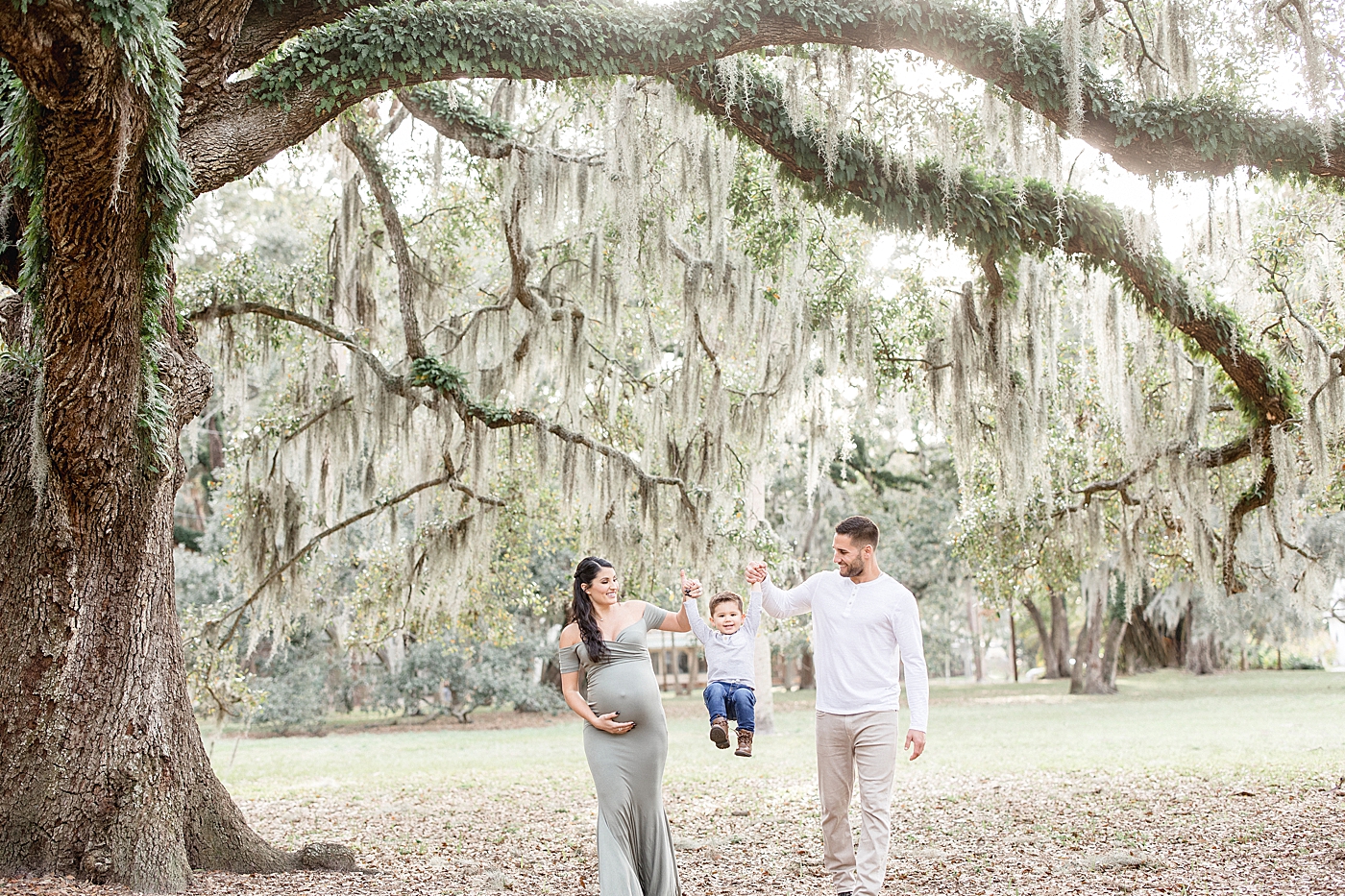Mom and Dad, Kevin Kiiermaier, swinging son under the oak trees in Tampa, FL. Photo by Brittany Elise Photography.