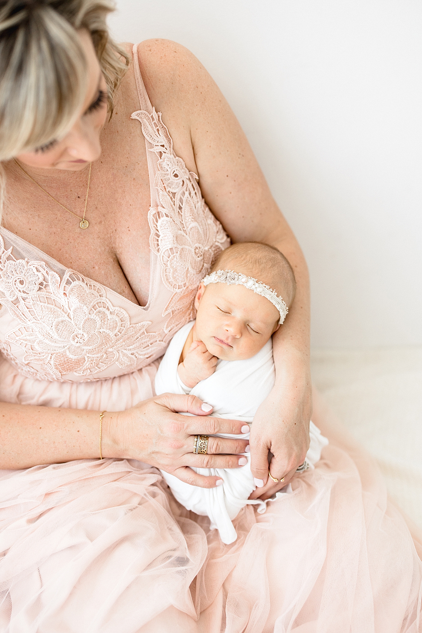 Mom holding her baby girl. Photo by Tampa Newborn Photographer, Brittany Elise Photography.