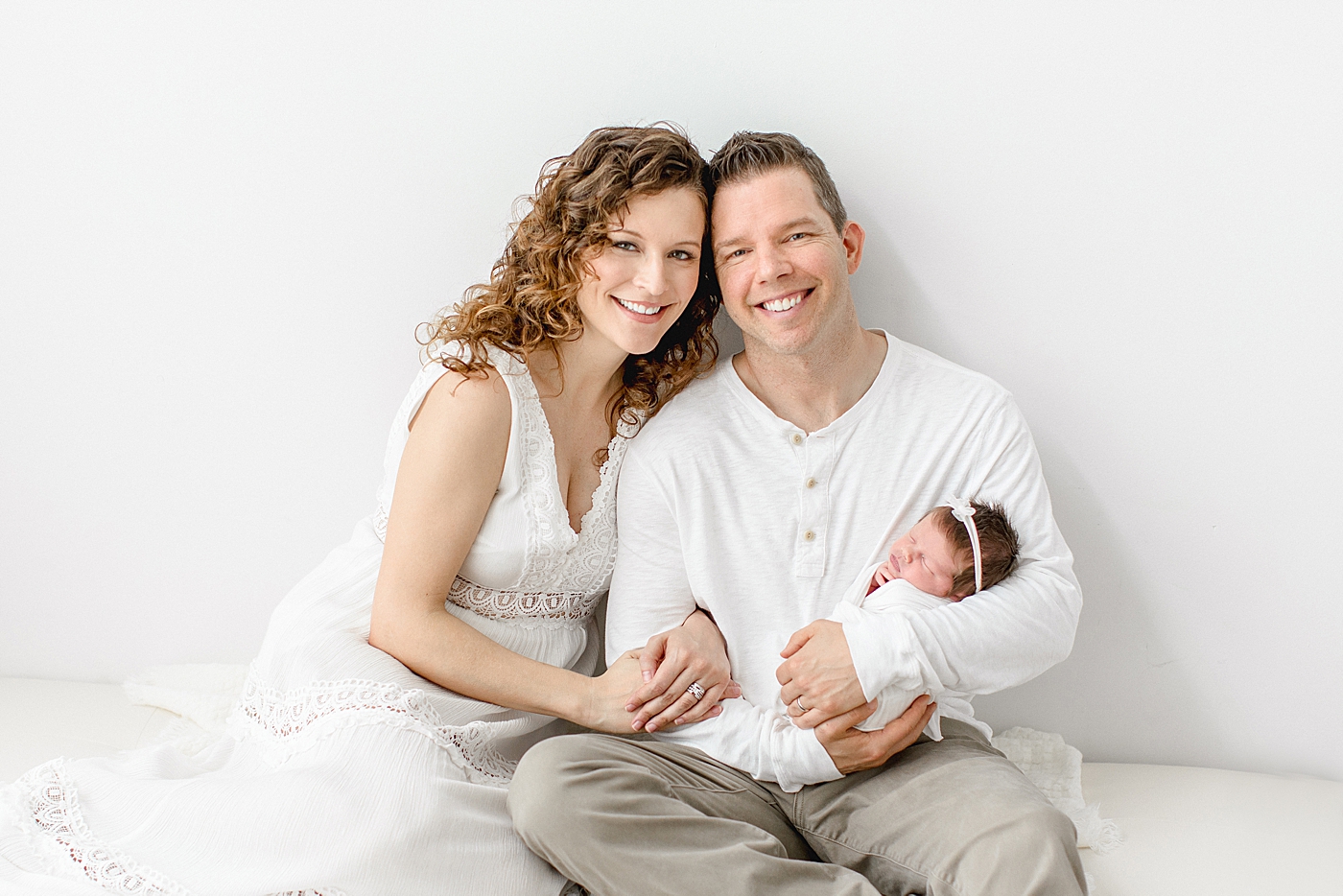 Mom and Dad holding their baby girl. Photo by Brittany Elise Photography.