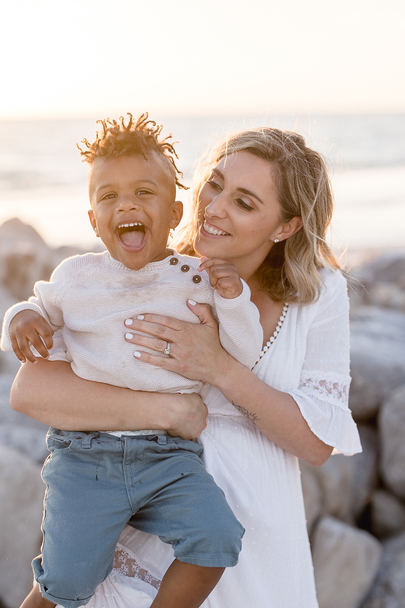 Mom holding her son and the two of them laughing. Photo by Brittany Elise Photography.