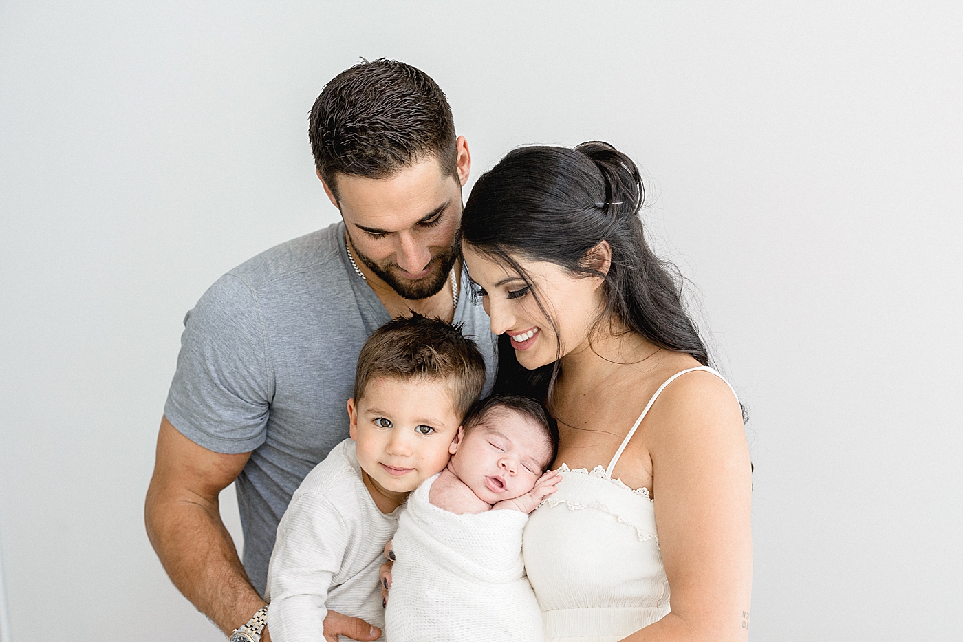 Sweet family moment during newborn session in Tampa photography studio with Brittany Elise Photography.