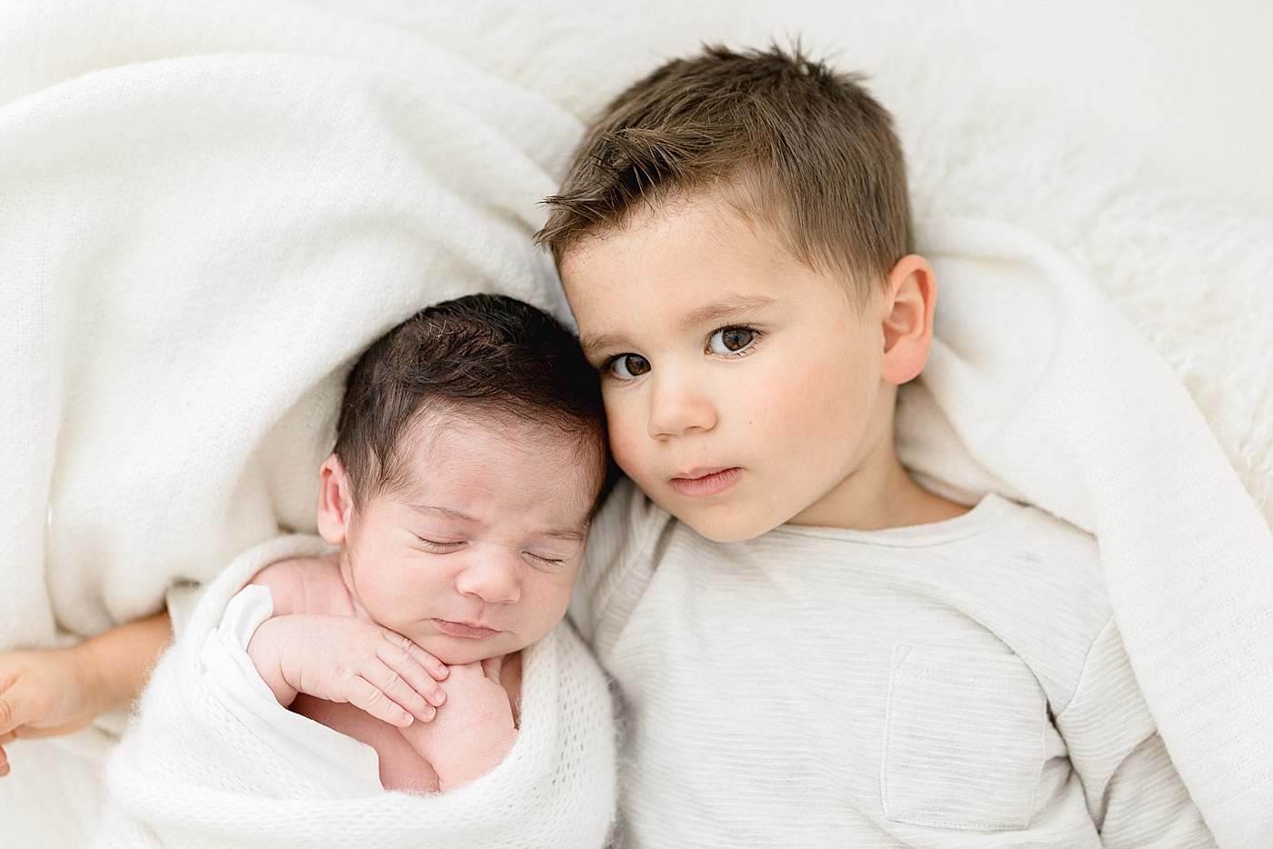Sibling photo of two brothers during newborn session with Brittany Elise Photography.