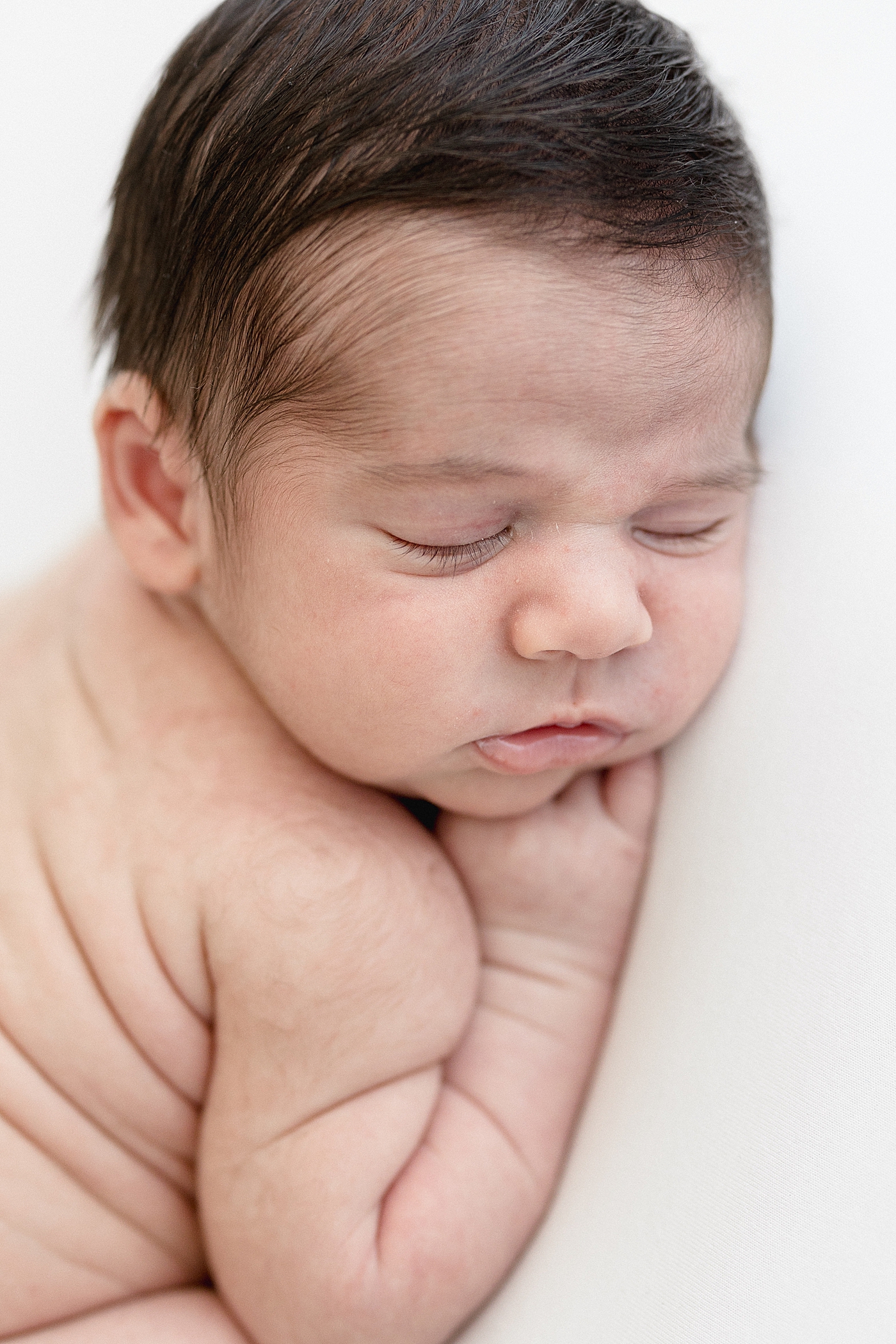 Baby laying on his stomach for newborn photos. Photo by Brittany Elise Photography.