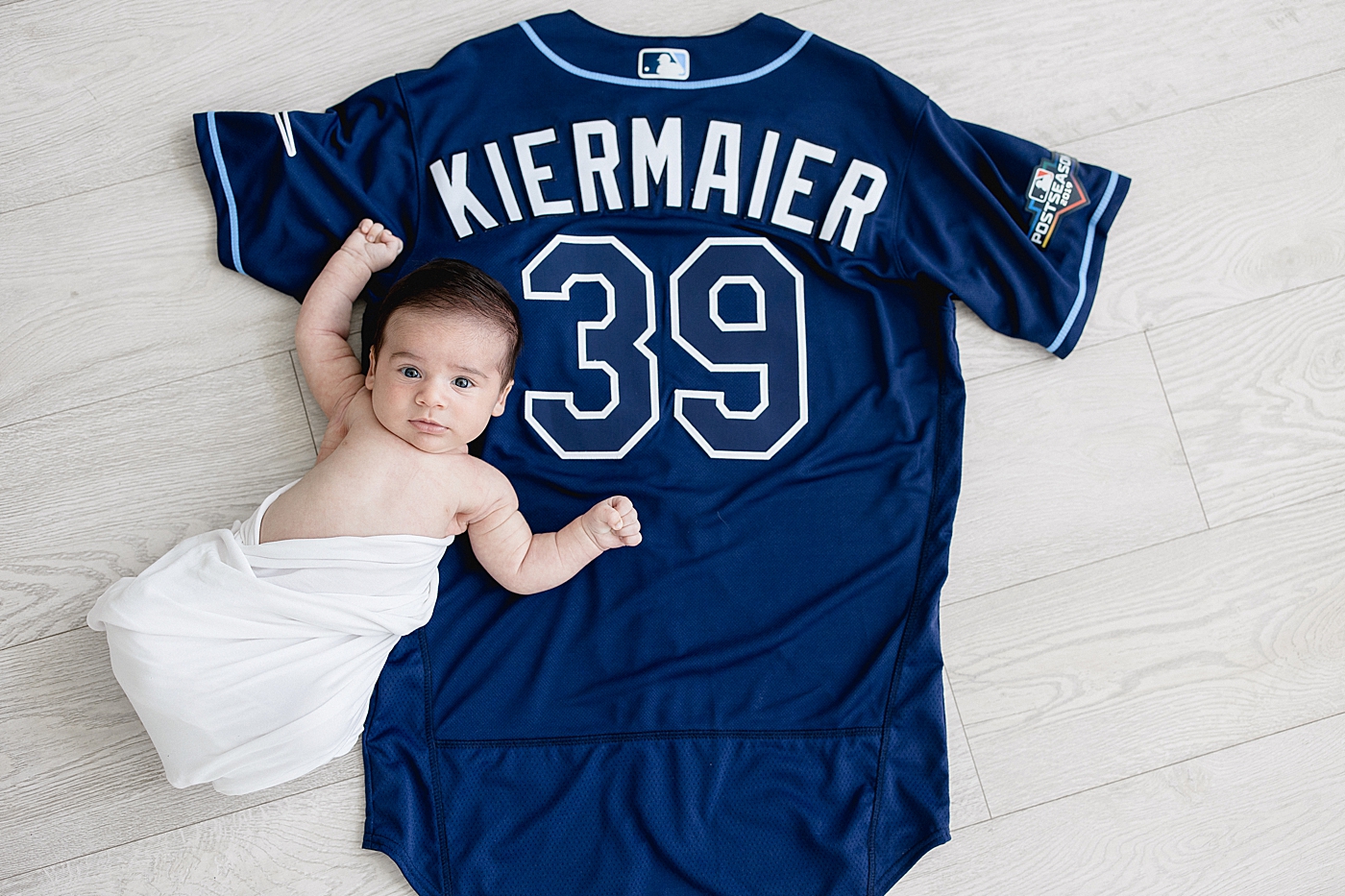 Newborn photo on baseball jersey for Kevin Kiermaier, center fielder for the Tampa Bay Rays. Photo by Brittany Elise Photography.