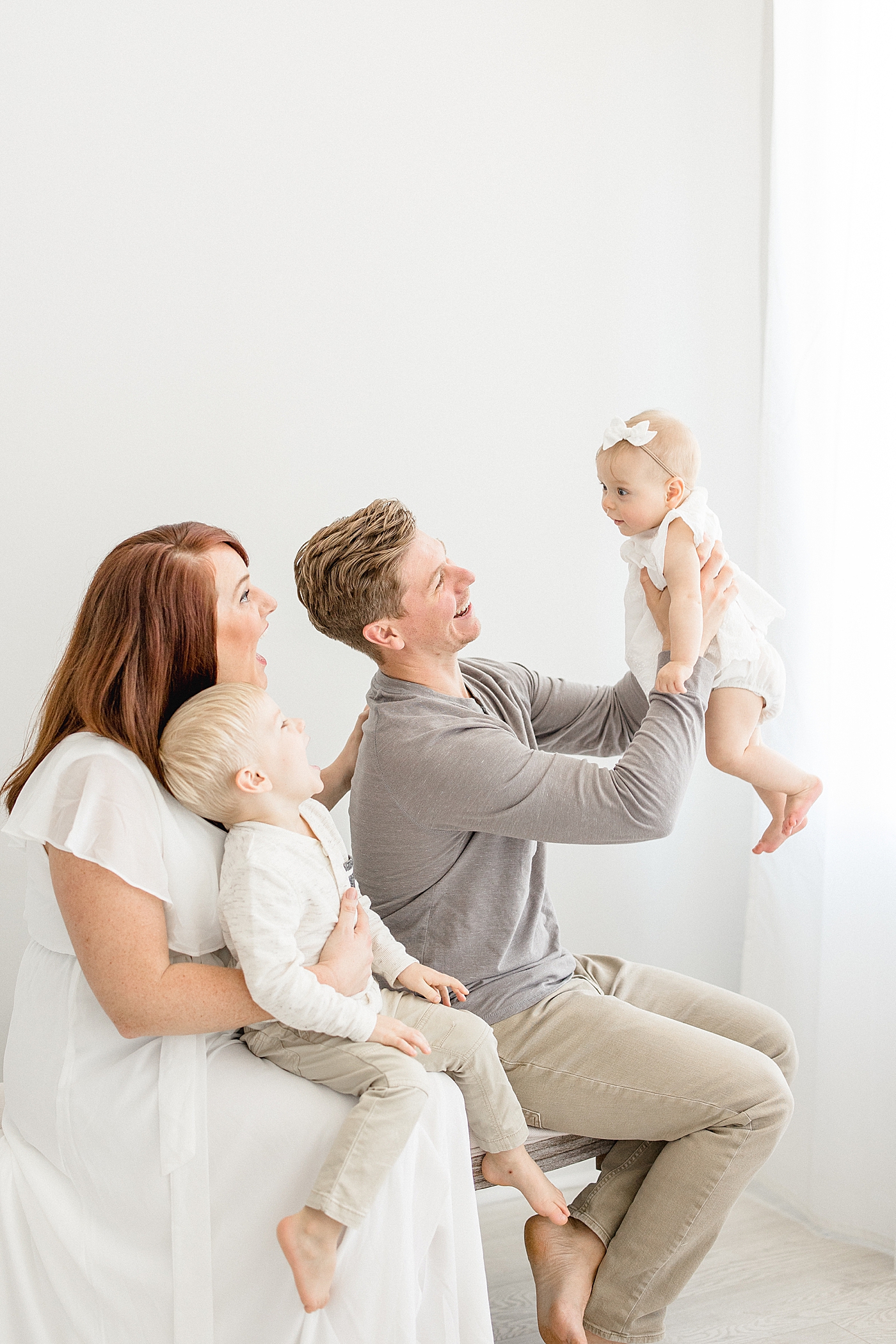 Family playing with six month old baby girl during photoshoot with Tampa baby and family photographer, Brittany Elise Photography.