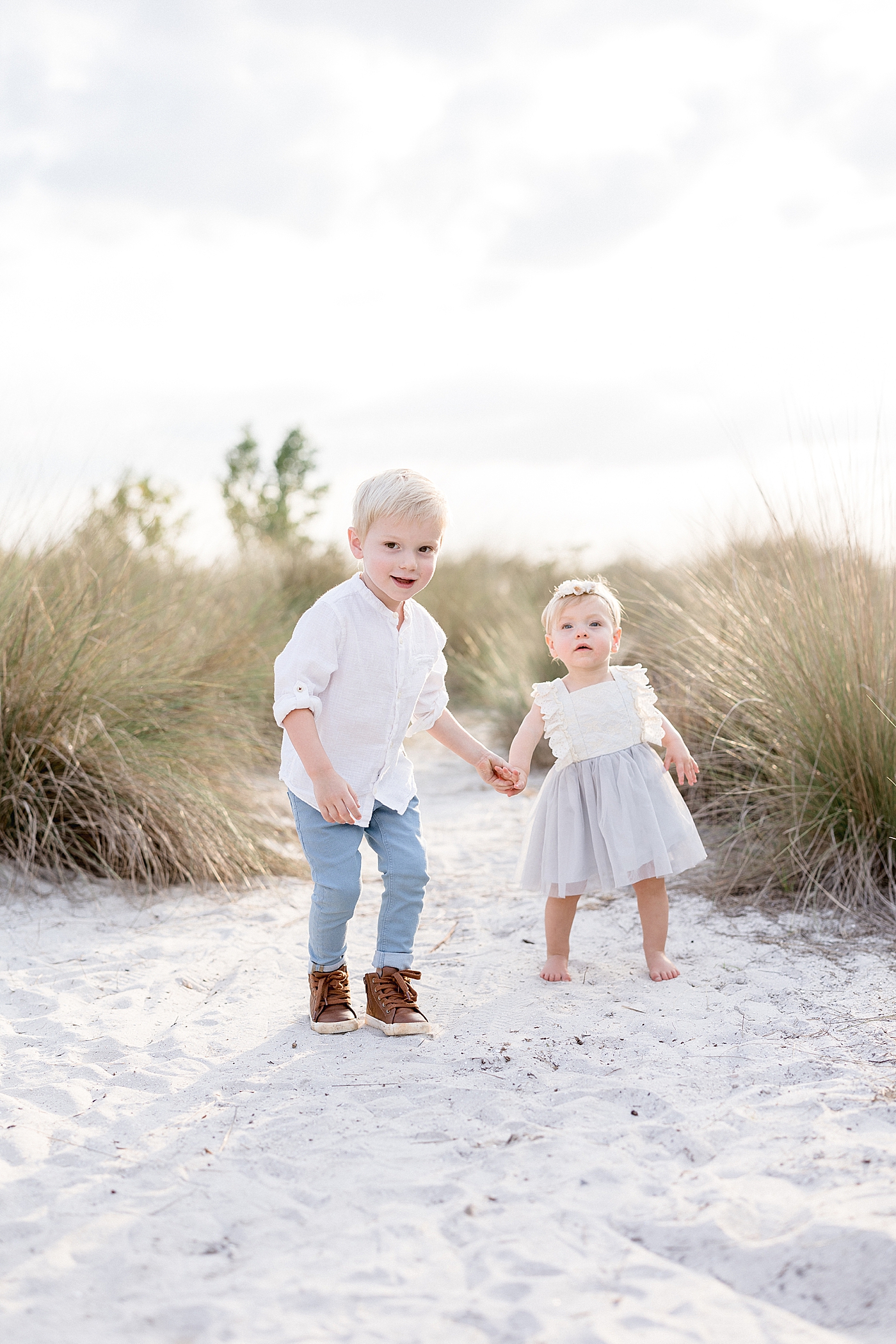 Brother and sister holding hands for photos with Brittany Elise Photography.