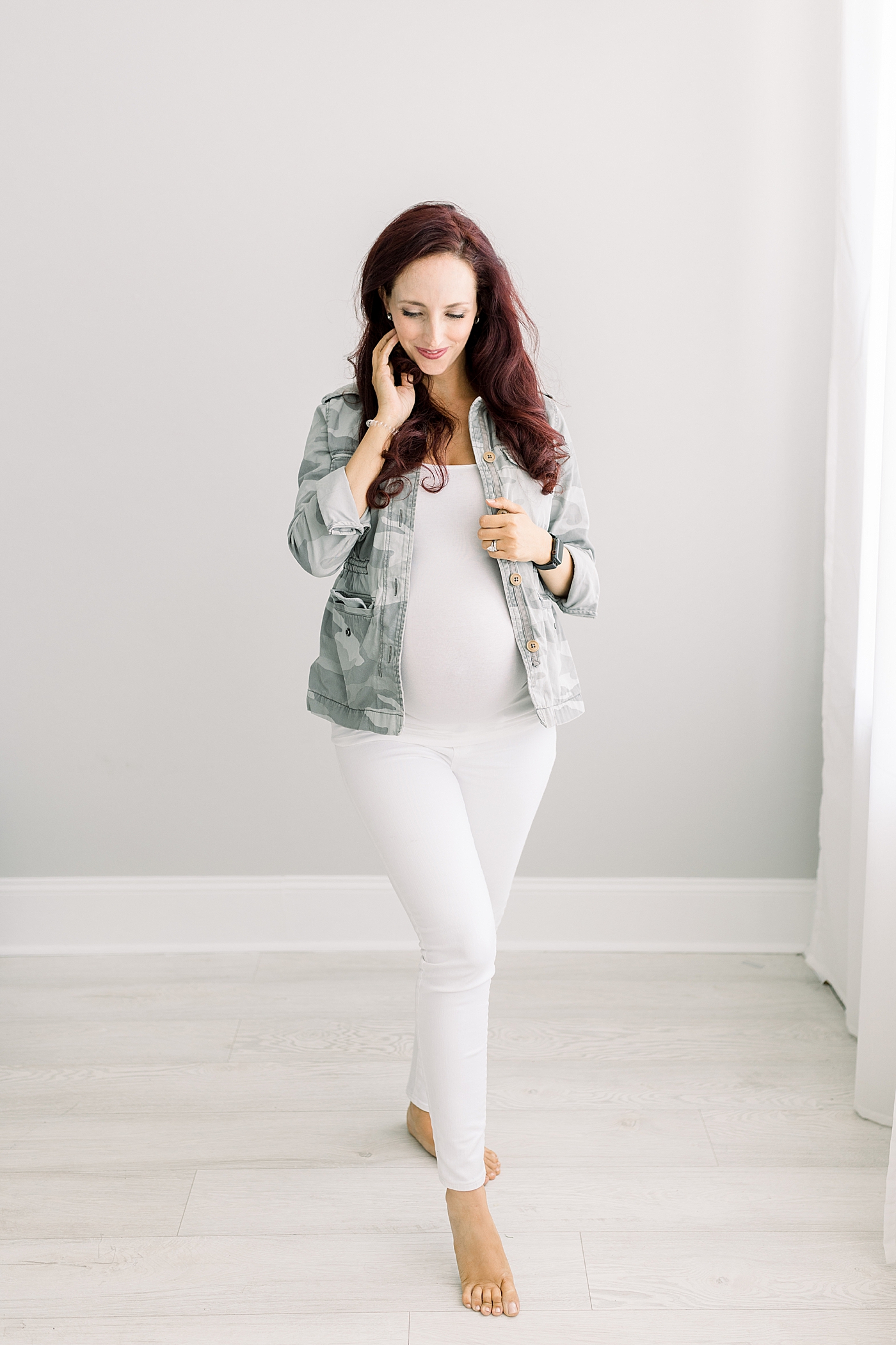 Pregnant mom wearing Abercrombie camo jacket with white Madewell maternity jeans. Photos of Brittany Elise Photography.