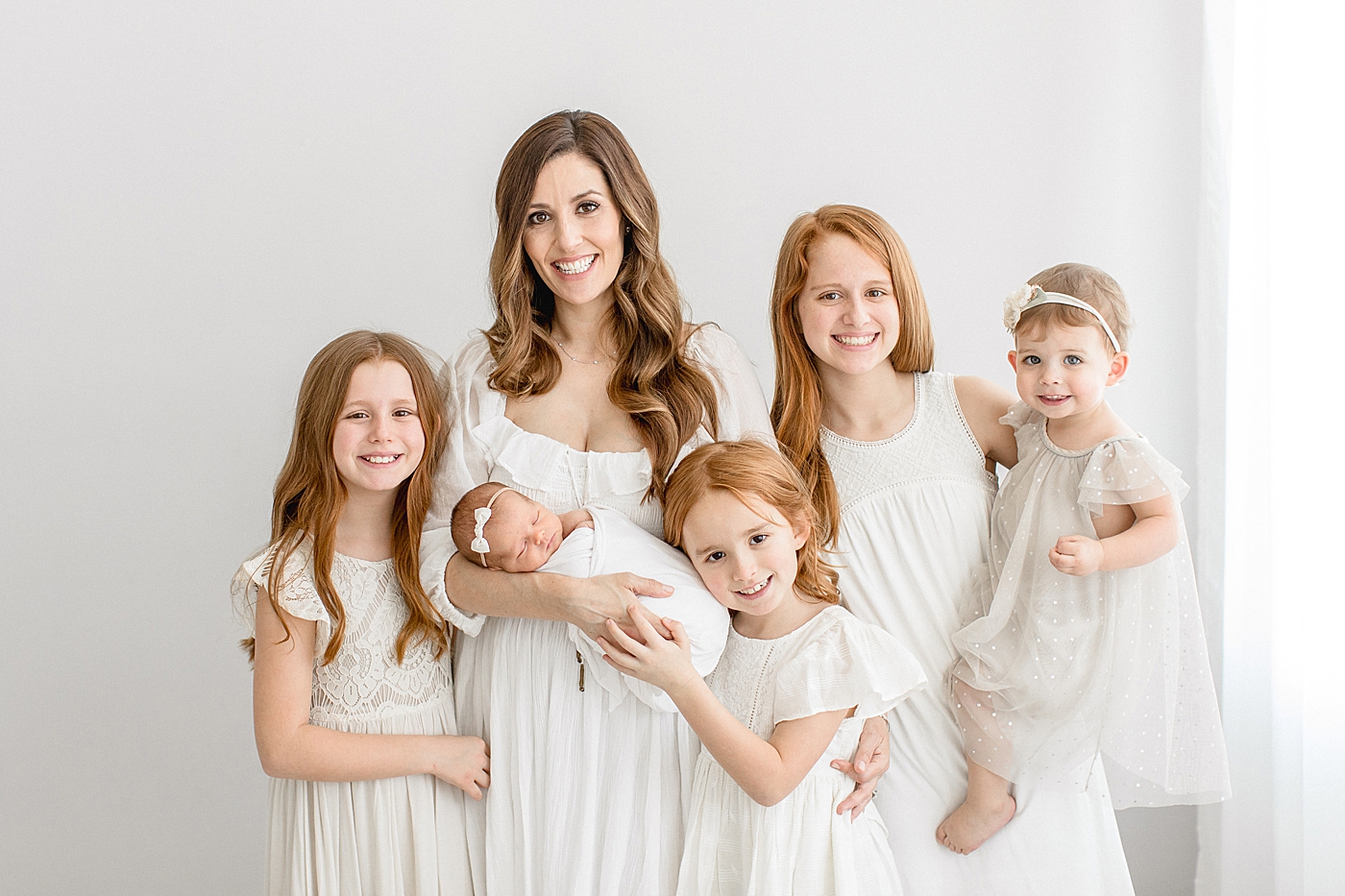 Mom with her five girls at youngest daughter's newborn session. Photo by Brittany Elise Photography.