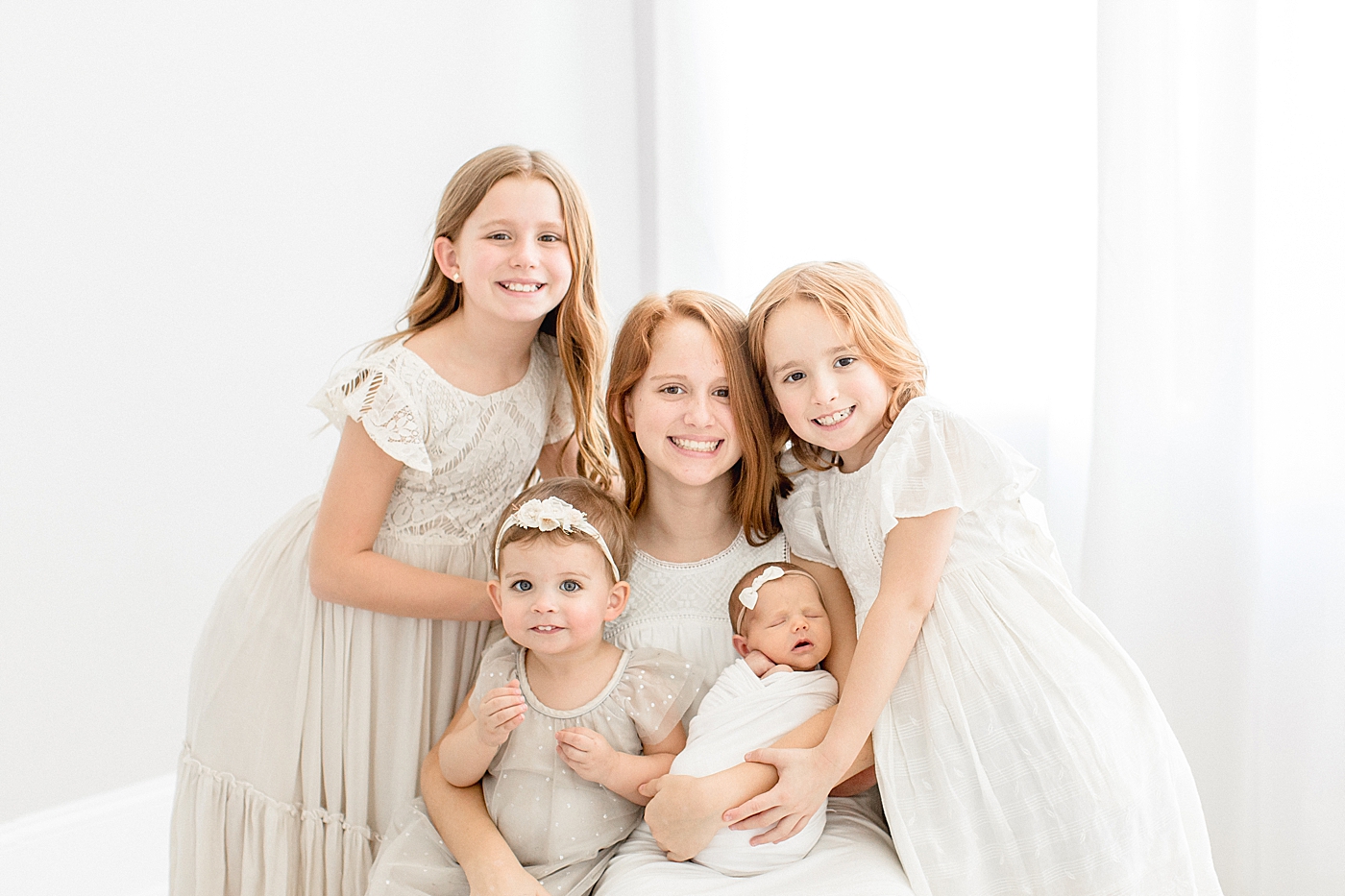 Sibling photo of five girls at newborn photoshoot in Tampa. Photo by Brittany Elise Photography.