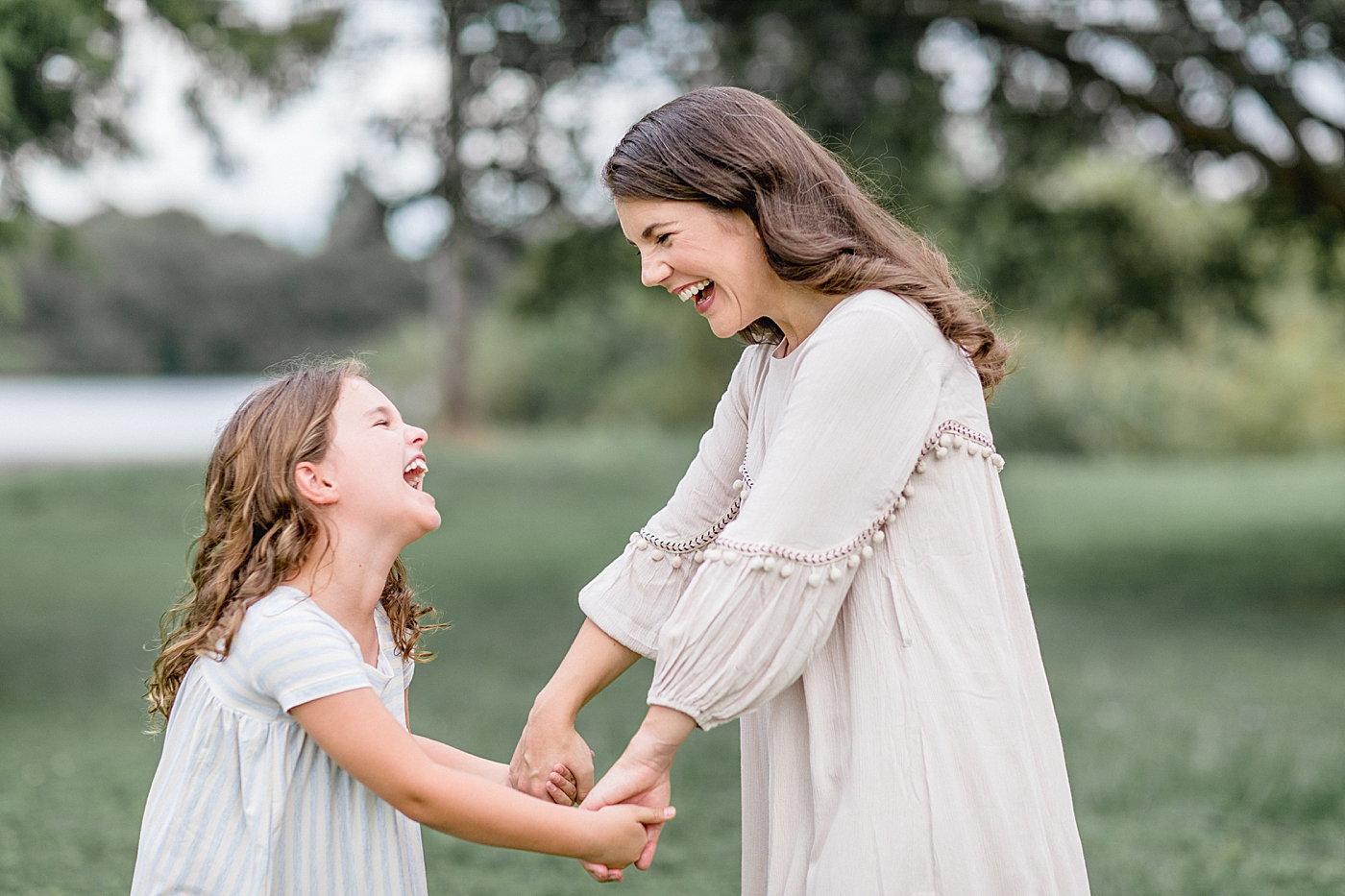 Mother looking at her daughter as they both laugh. Photo by Brittany Elise Photography.