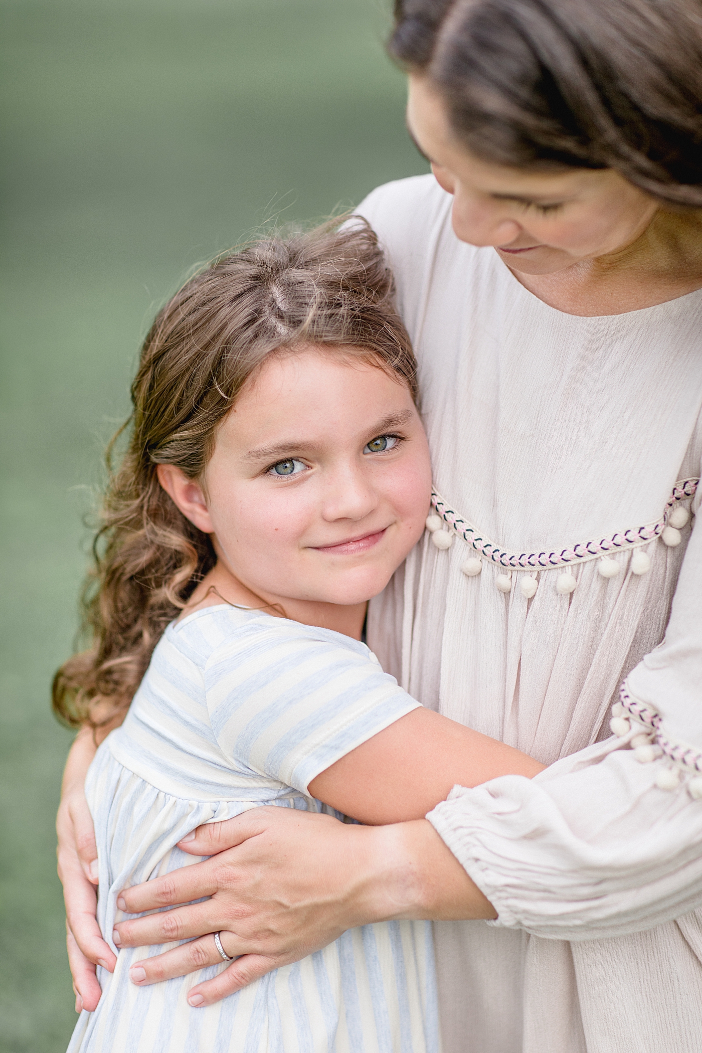 Daughter resting her head on Mom's shoulder for a photo. Photo by Brittany Elise Photography.