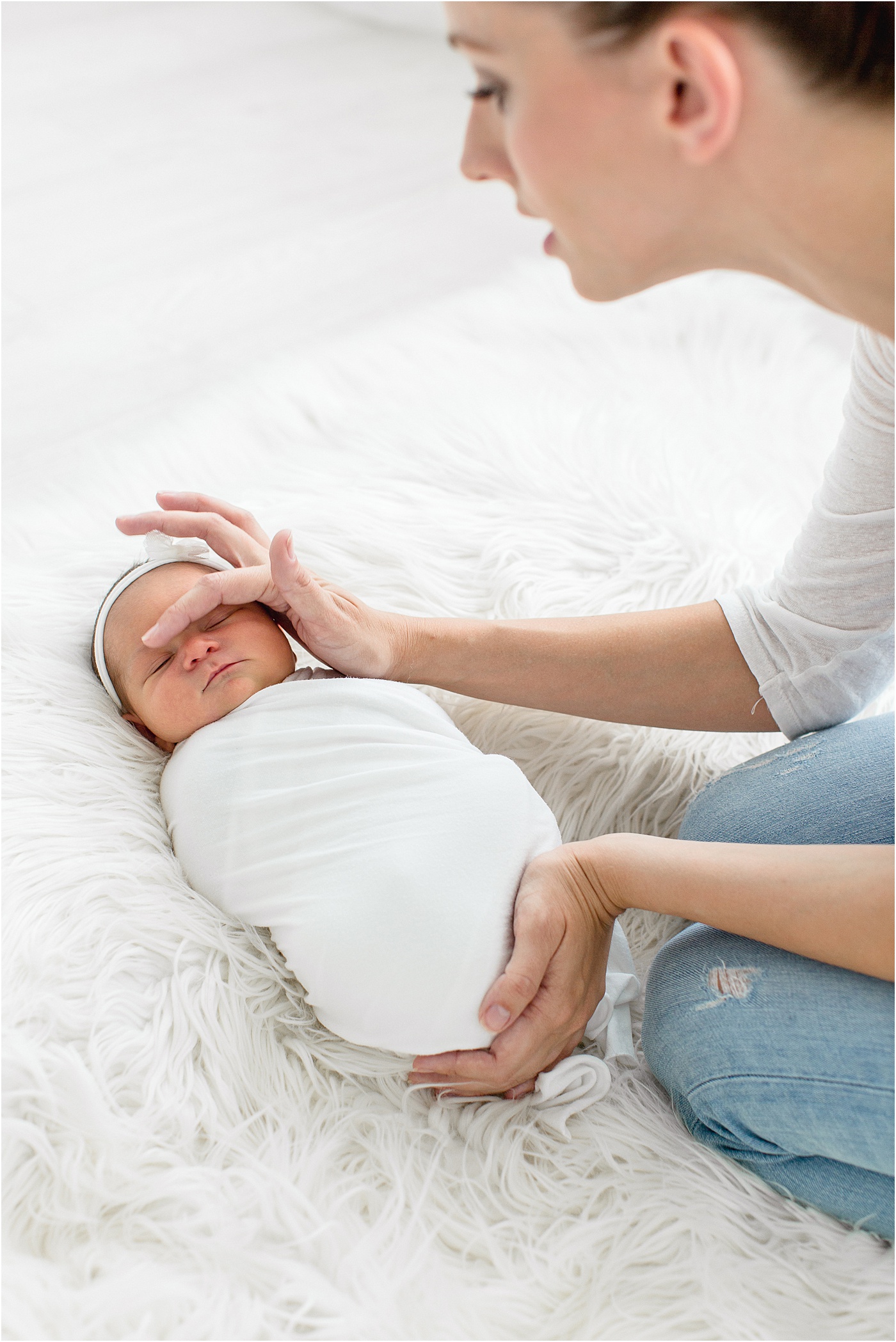 Brittany Elise Photography soothing baby to sleep during newborn session in Tampa, FL.