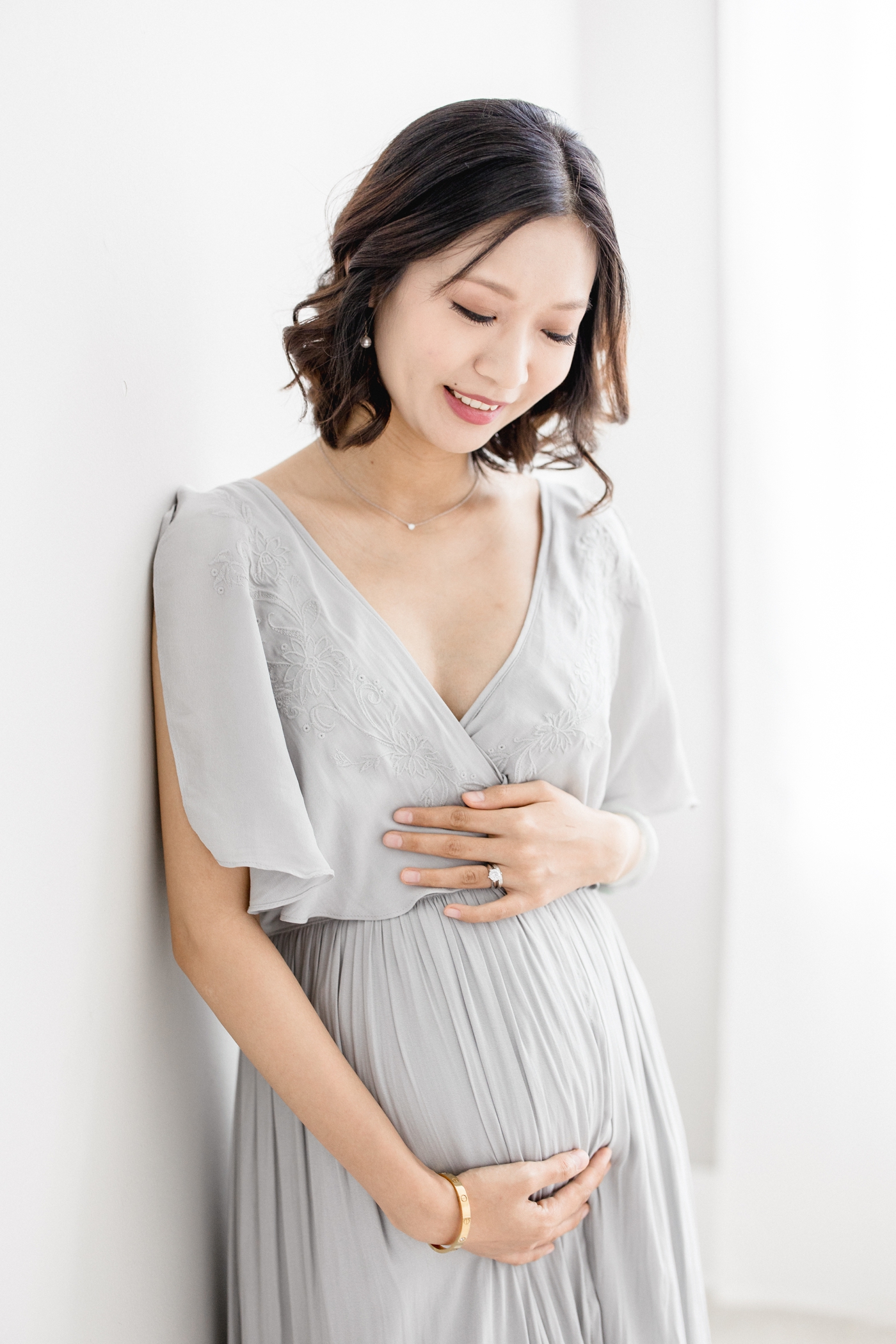Expecting mom wearing a Free People dress for a studio maternity session with Brittany Elise Photography.