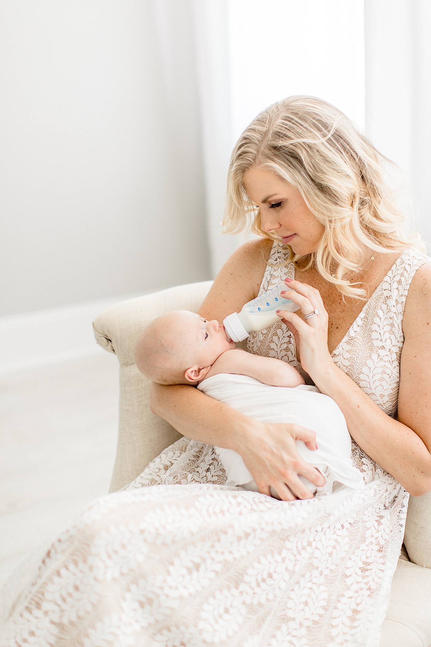 Mom bottle feeding baby breastmilk. Photo by Brittany Elise Photography.