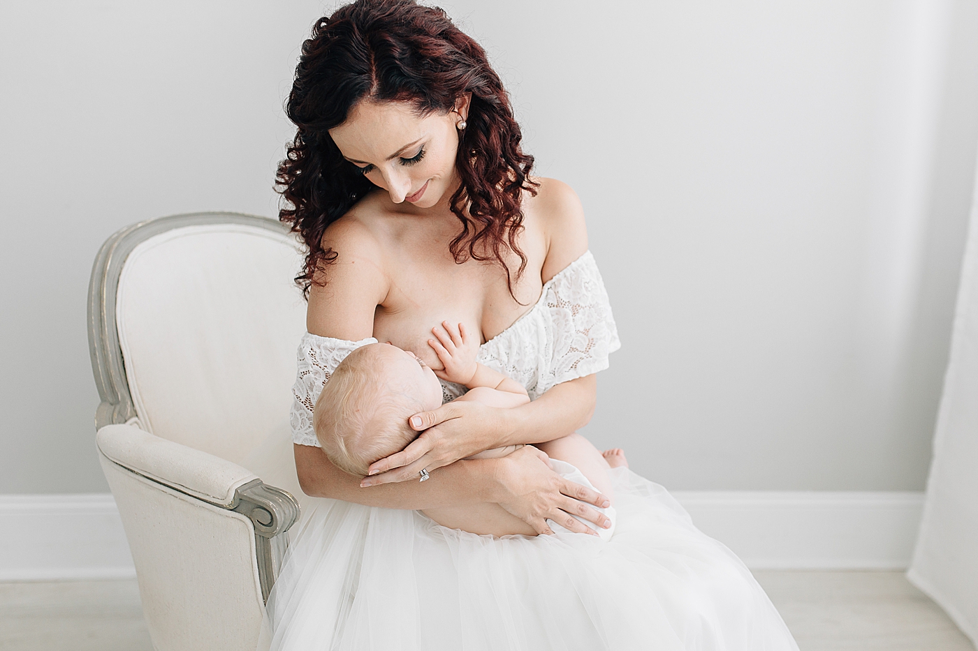 Mom breastfeeding baby during photoshoot. Photo by Bethany Bakus Photography for Brittany Elise in Tampa, Fl.