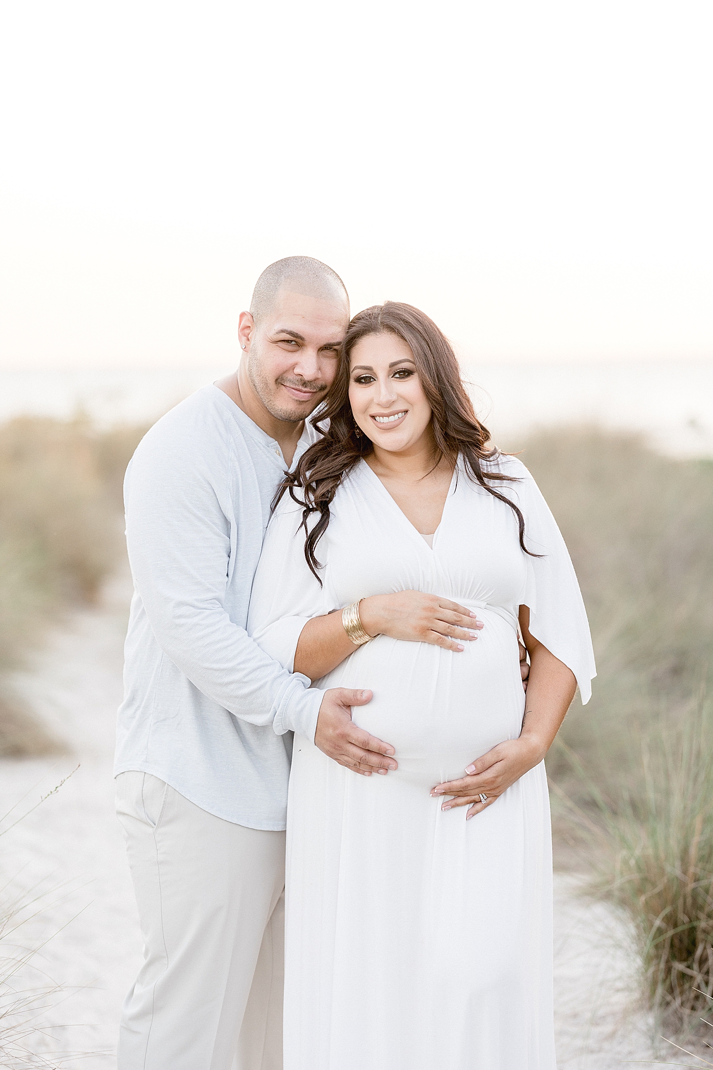 Couple posing together for maternity photos with Tampa photographer, Brittany Elise Photography.