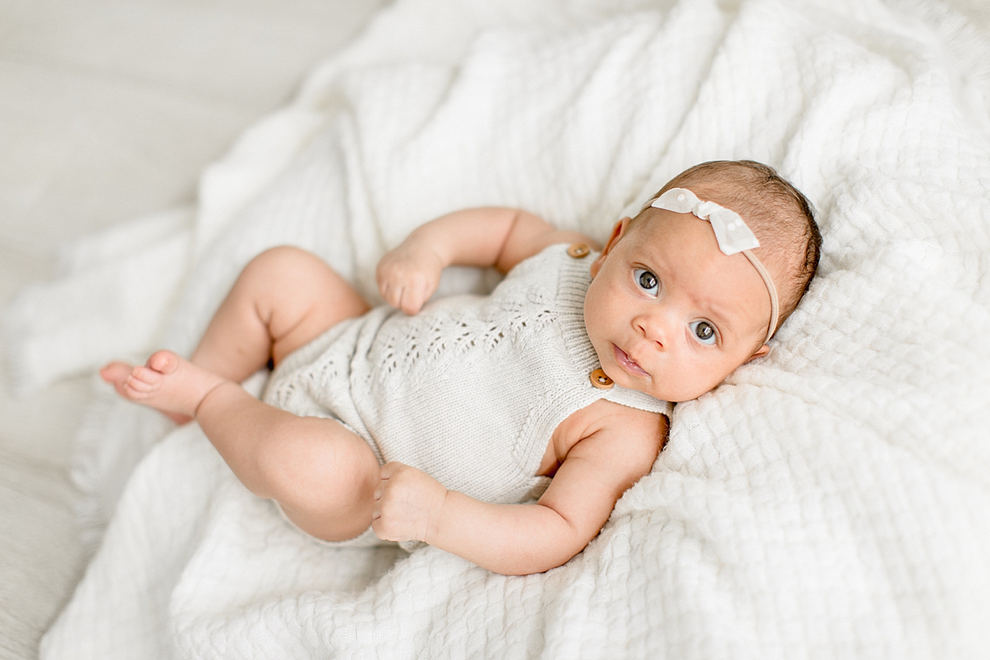 Newborn baby girl wide awake for photos with Brittany Elise Photography.