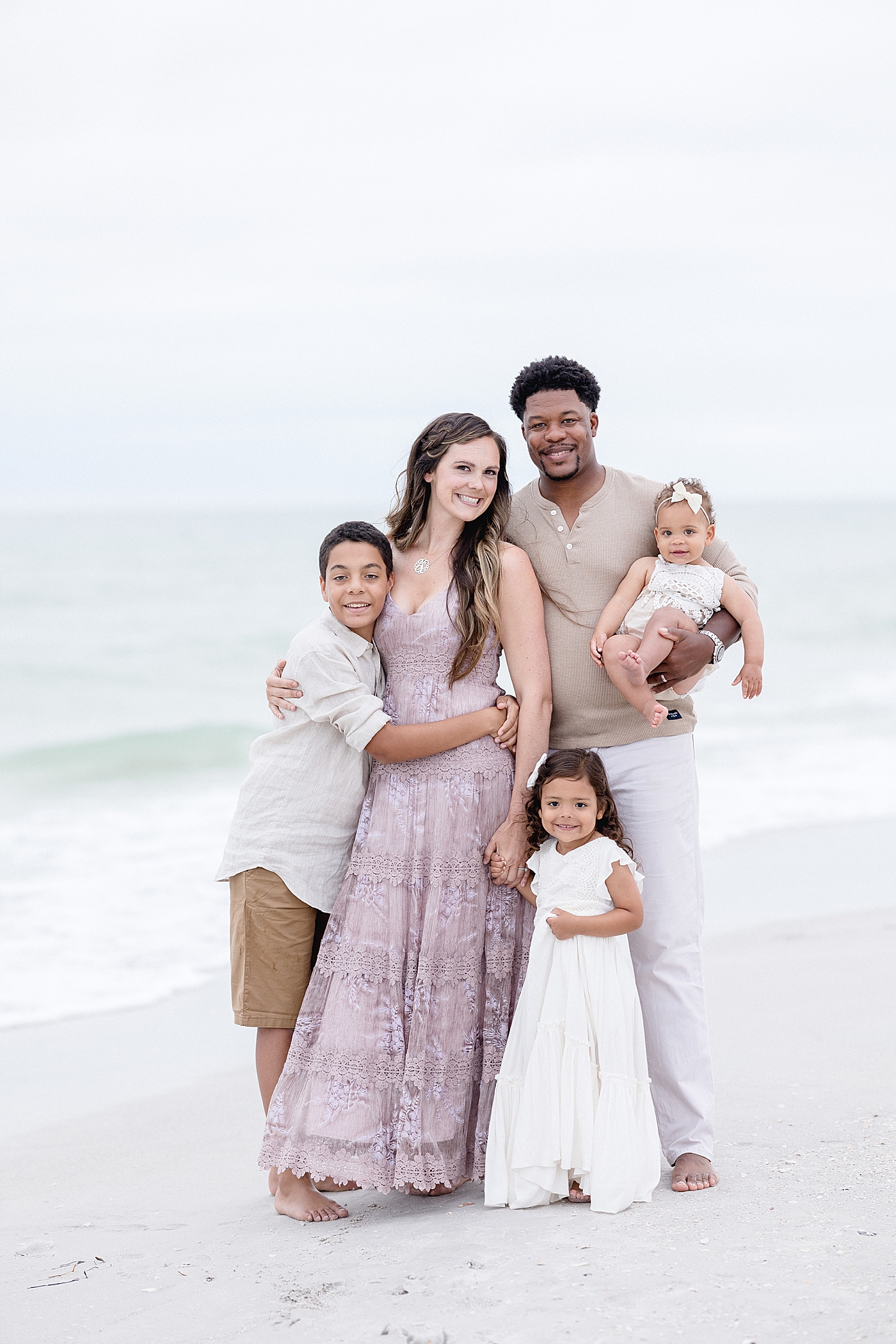 Family of five on the beach. Photo by Brittany Elise Photography.