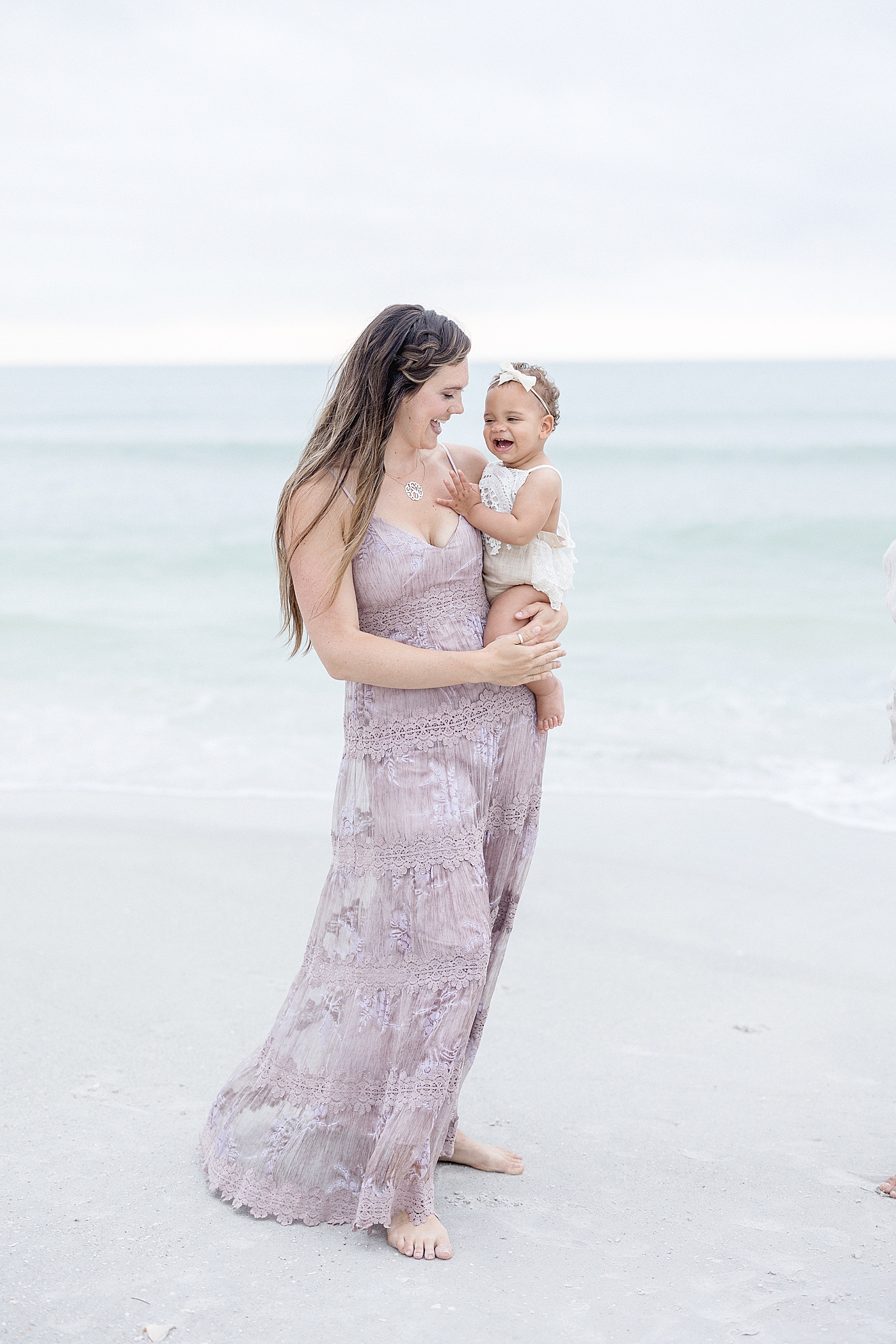Mom and daughter by the water on St. Pete Beach. Photo by Brittany Elise Photography.