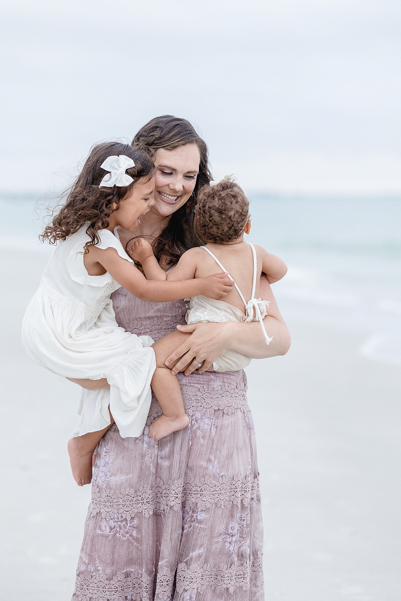 Mom hugging her two girls. Photo by Brittany Elise Photography.