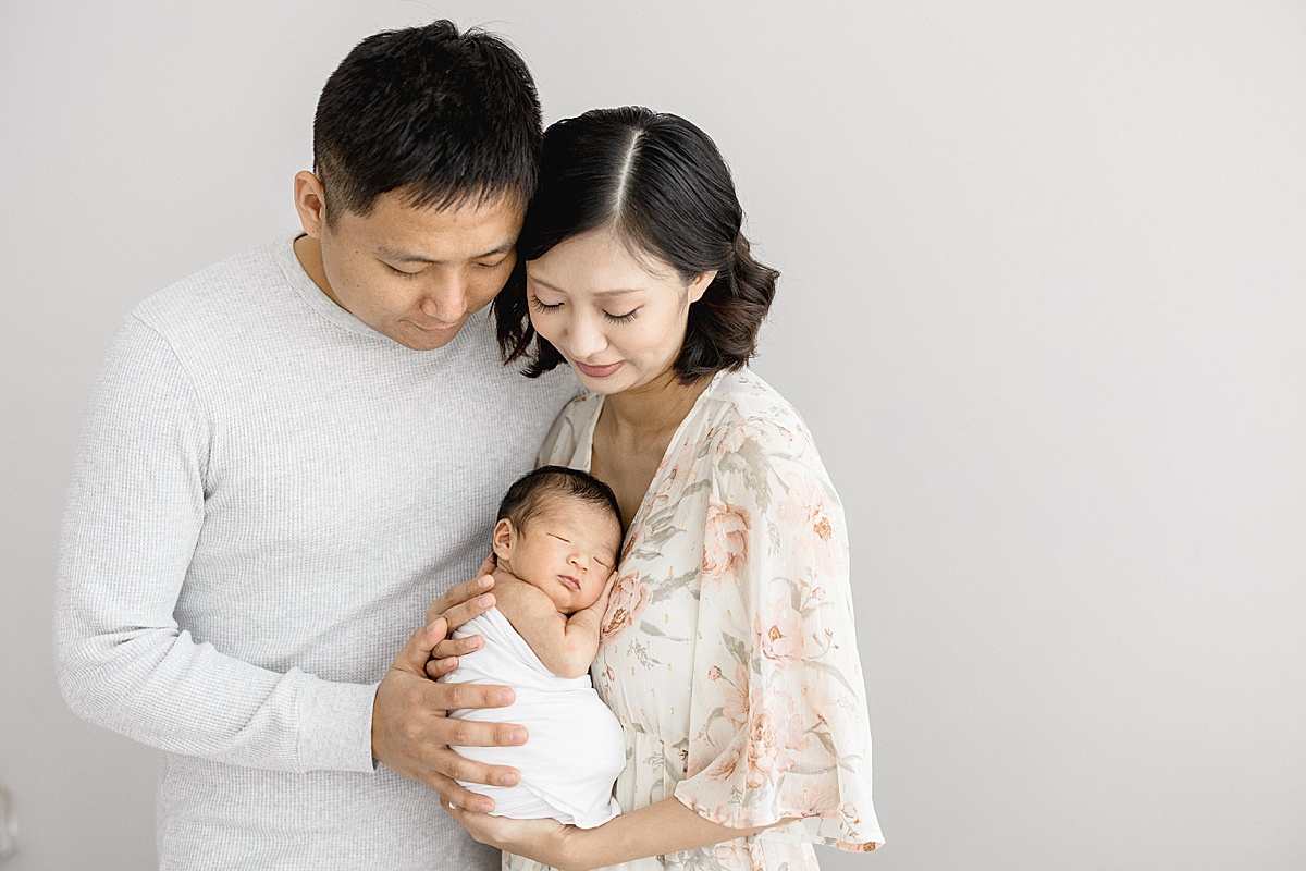 Family portrait with first-time parents and son. Photo by Tampa newborn photographer, Brittany Elise Photography.