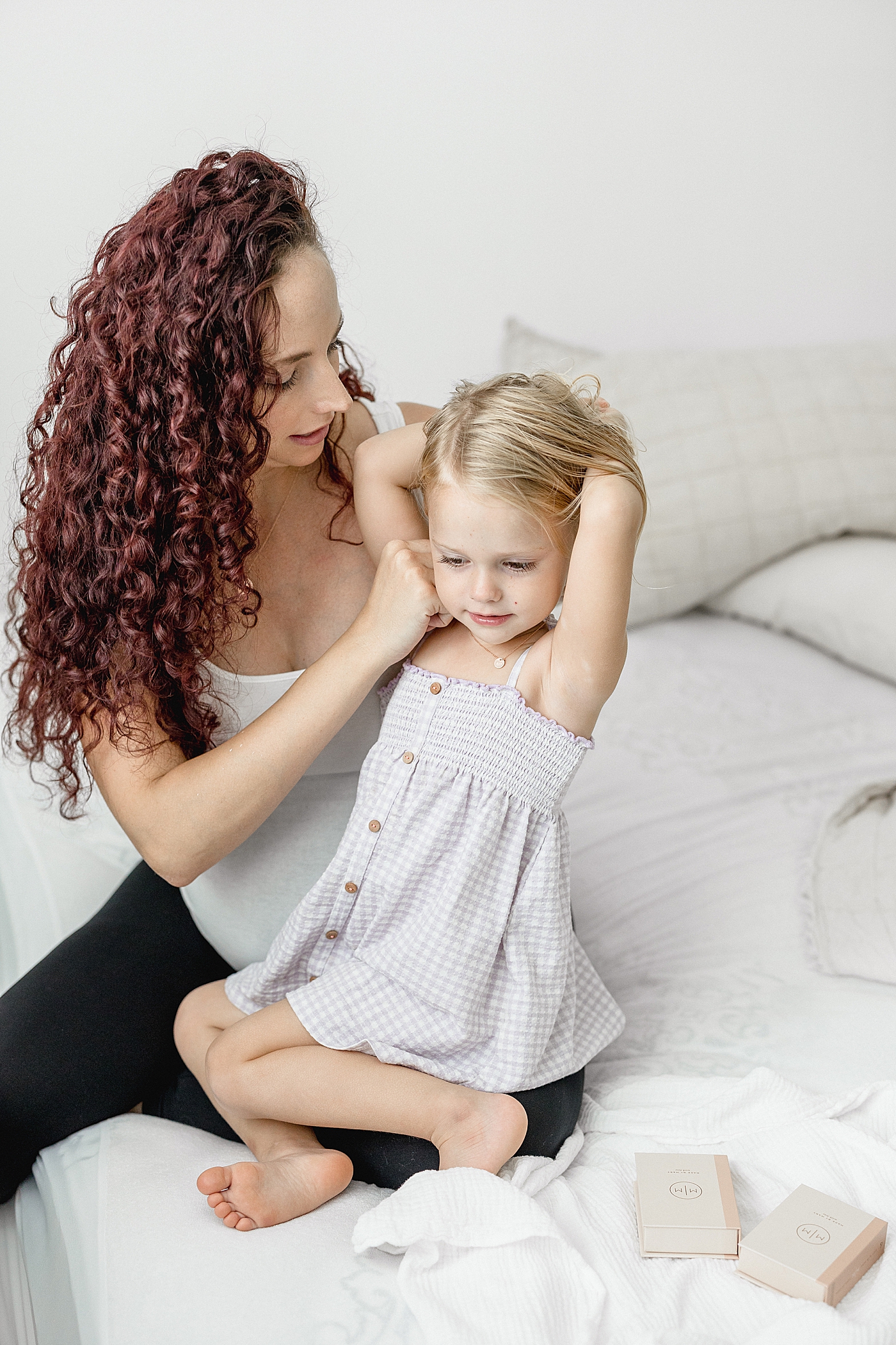 Mom gifting daughter a necklace for baby sister arrives. Photo by Brittany Elise Photography.