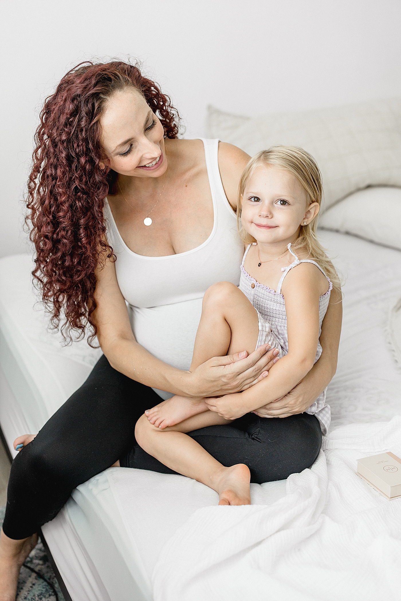 Mom gifting daughter a necklace for baby sister arrives. Photo by Brittany Elise Photography.