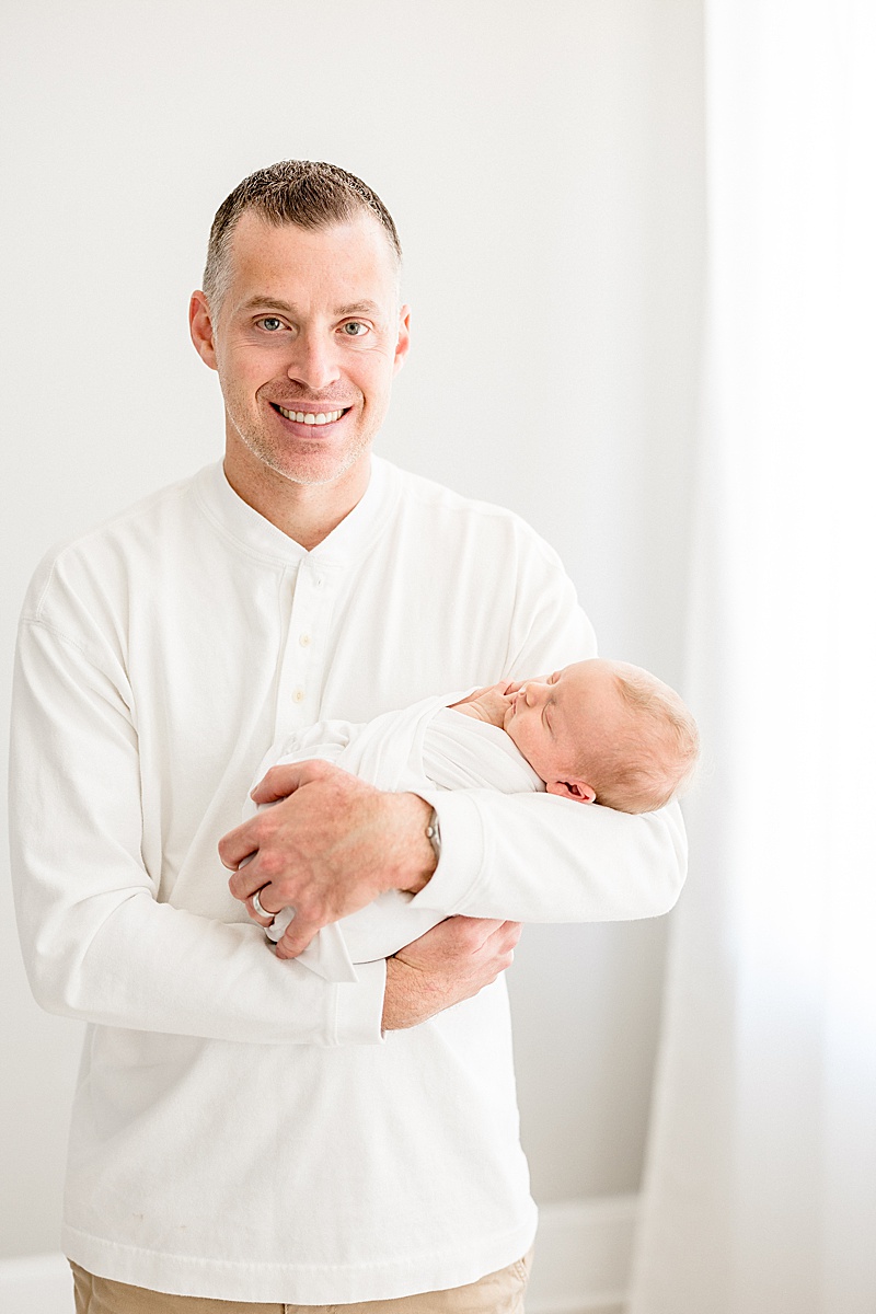 Father-son photo during newborn session with Brittany Elise Photography.