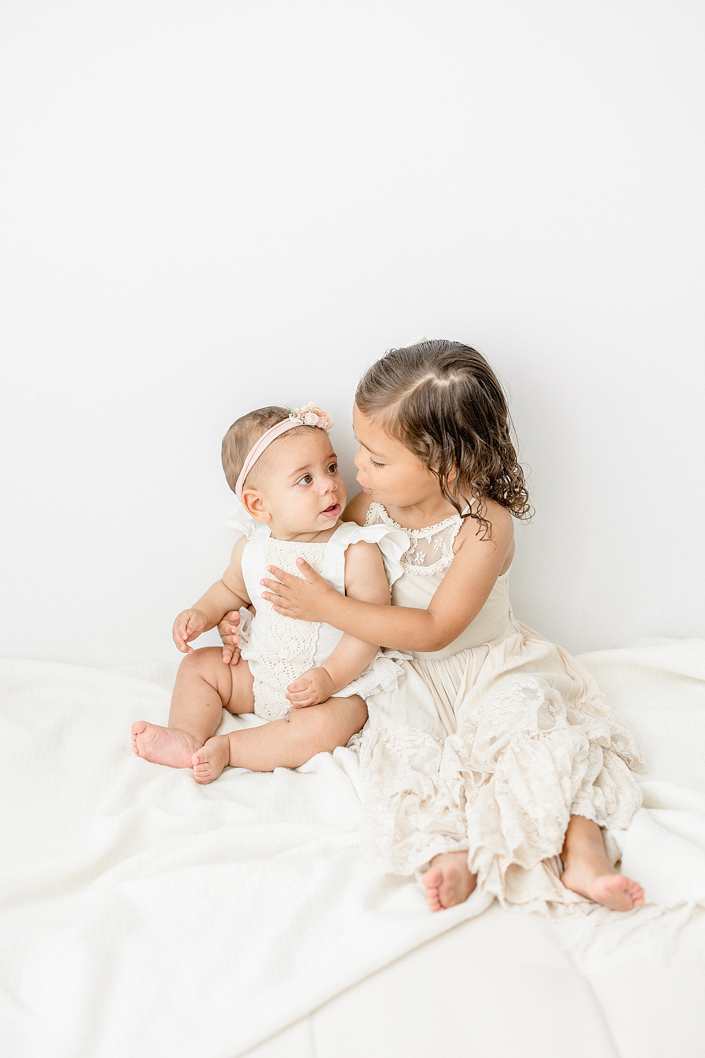 Sisters looking at each other. Photo by Brittany Elise Photography.