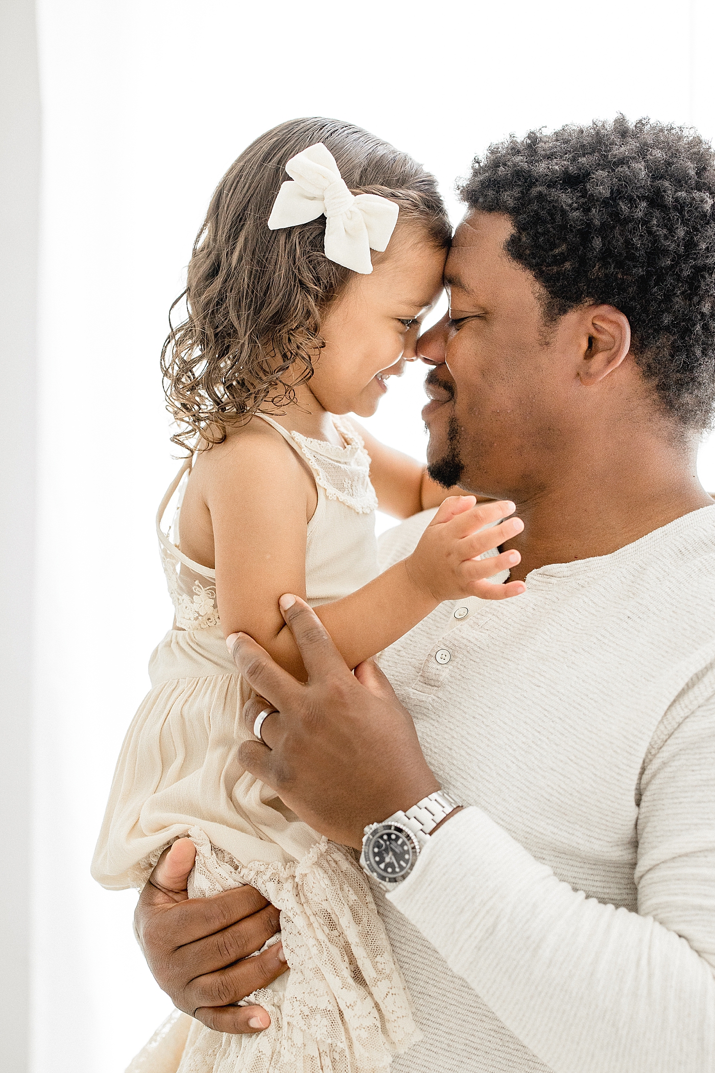 Sweet moment between Father and toddler-aged daughter. Photo by Brittany Elise Photography.