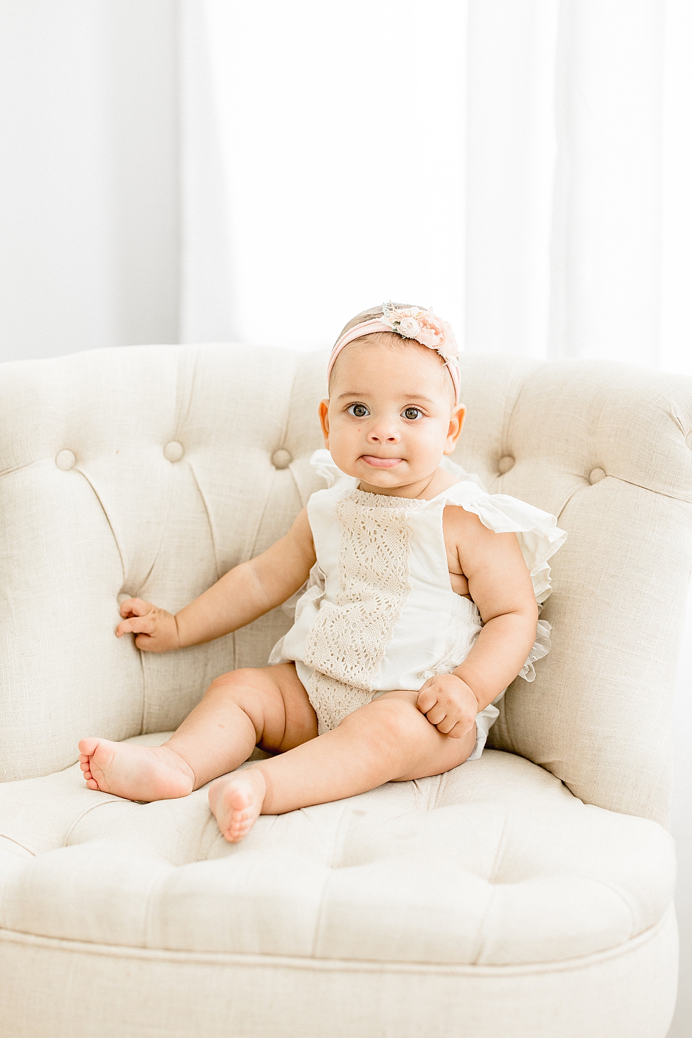 Baby girl in studio celebrating turning six months old. Photo by Brittany Elise Photography.