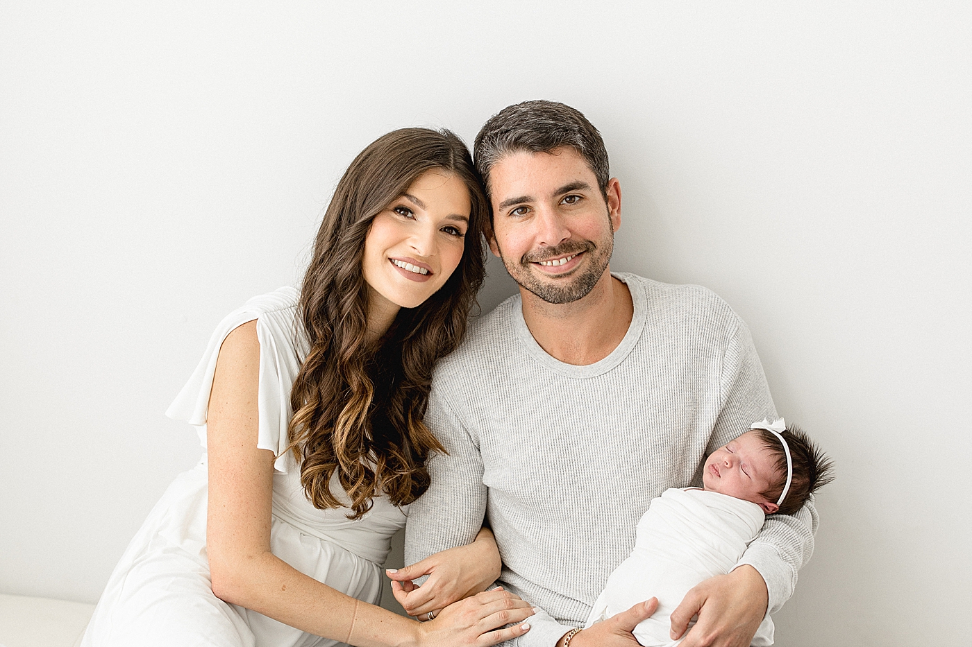 Mom and Dad holding their daughter. Photos by Brittany Elise Photography.