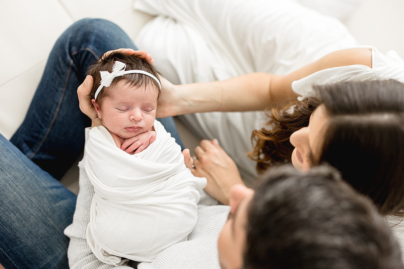 Parents holding their baby girl in their hands. Photos by Brittany Elise Photography.