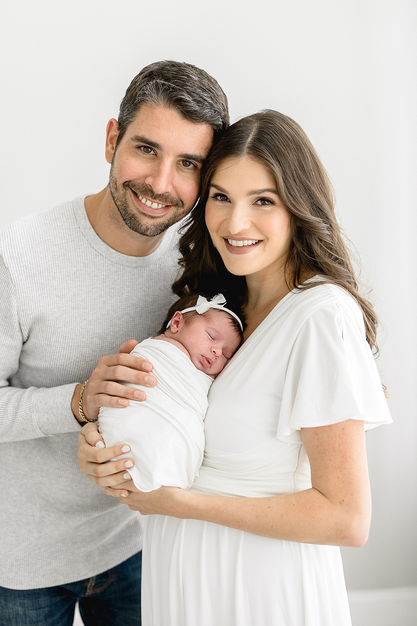 Family photo of Mom, Dad and baby girl. Photos by Brittany Elise Photography.