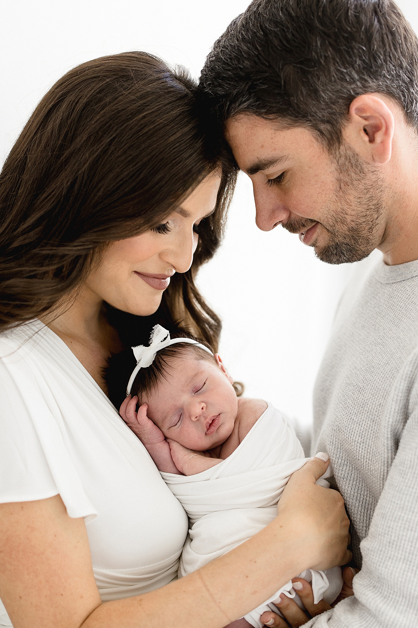 Studio newborn session in Tampa, FL for baby girl and new parents. Photos by Brittany Elise Photography.