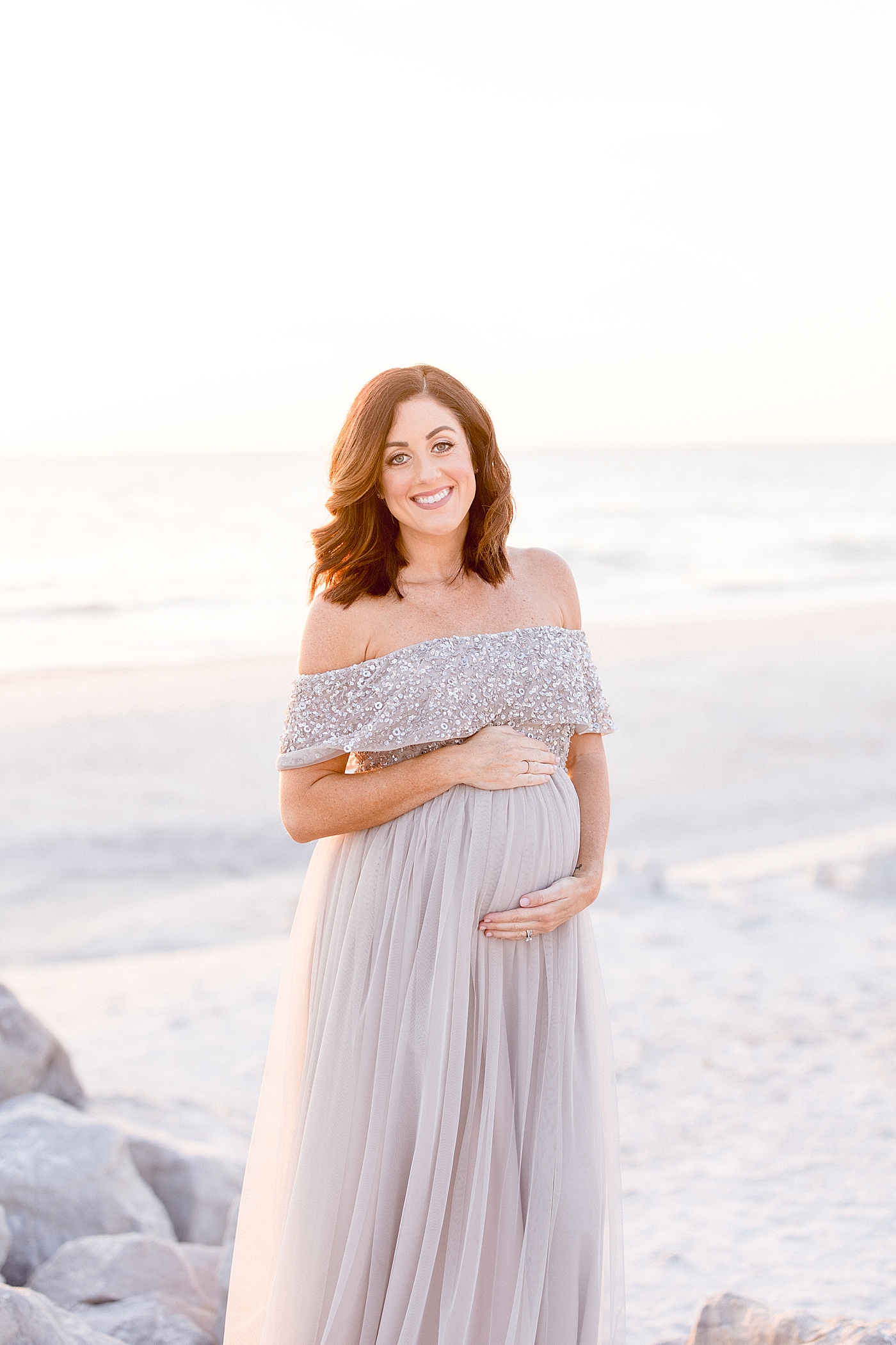 Maternity session at sunset at St Pete Beach in Tampa, FL. Photo by Brittany Elise Photography.