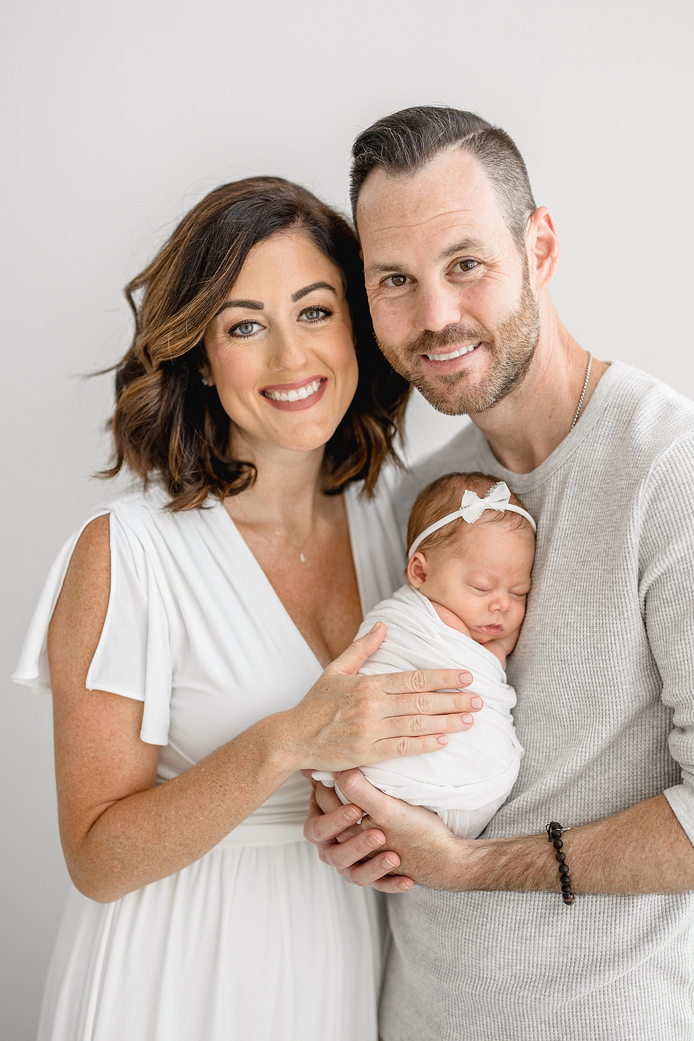 New parents with premie newborn daughter. Photo by Brittany Elise Photography.