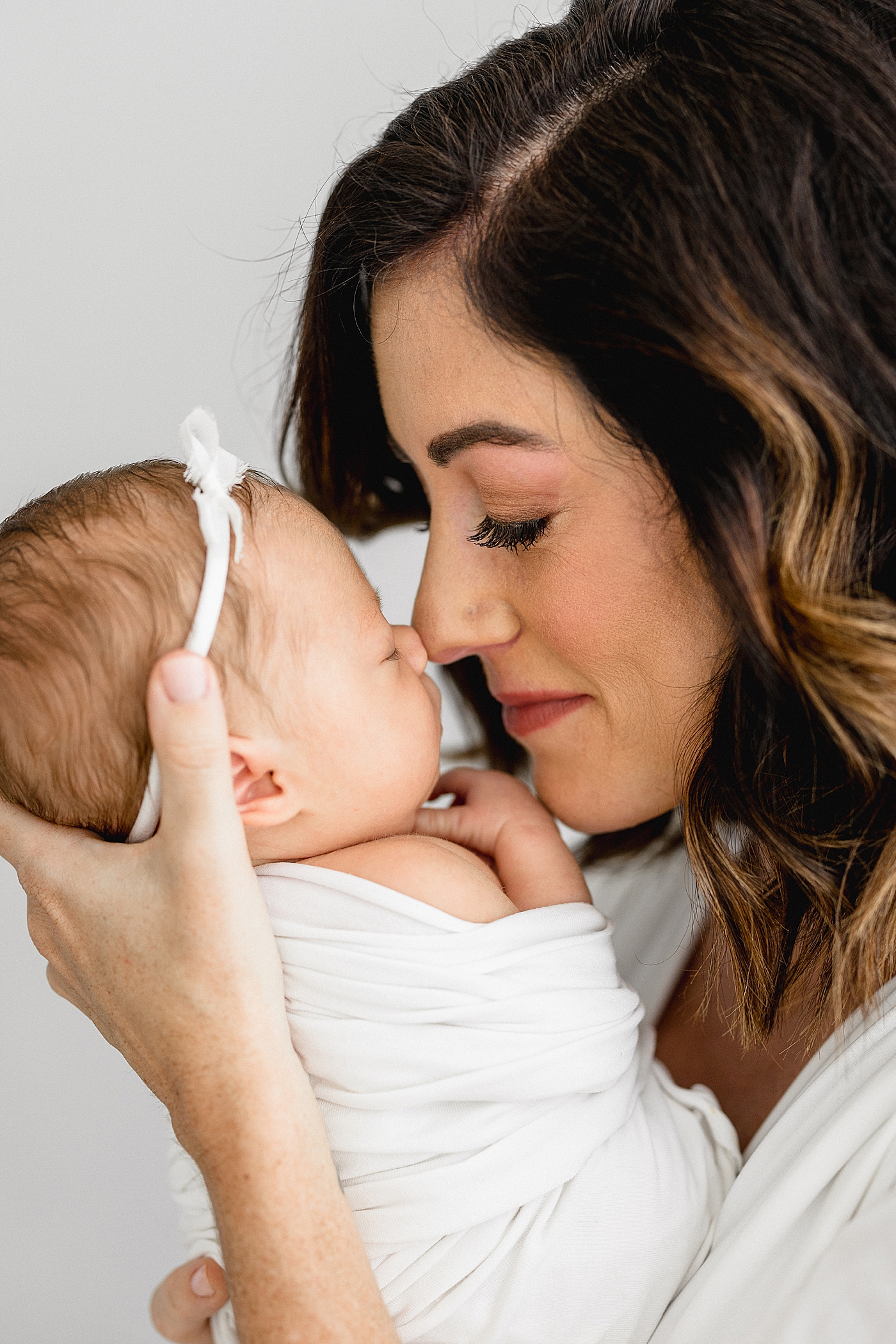 Mom nose-to-nose with daughter. Photo by Brittany Elise Photography.